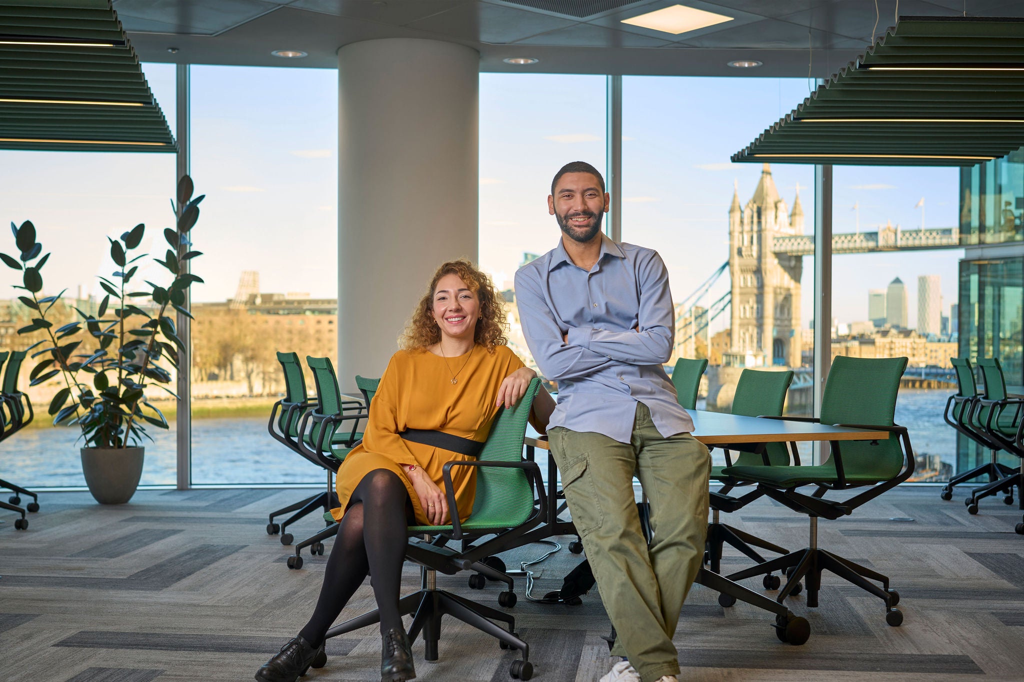 Two colleagues standing in front of a city skyline