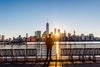 Rear view of a man looking at New York City skyline at sunrise, USA