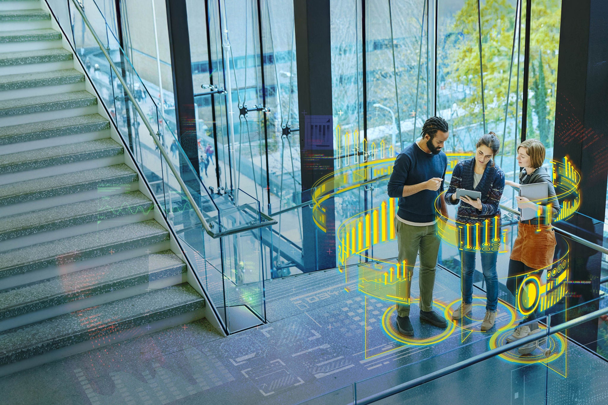 Professionals reviewing digital data on a tablet in a modern office with analytics visualization.