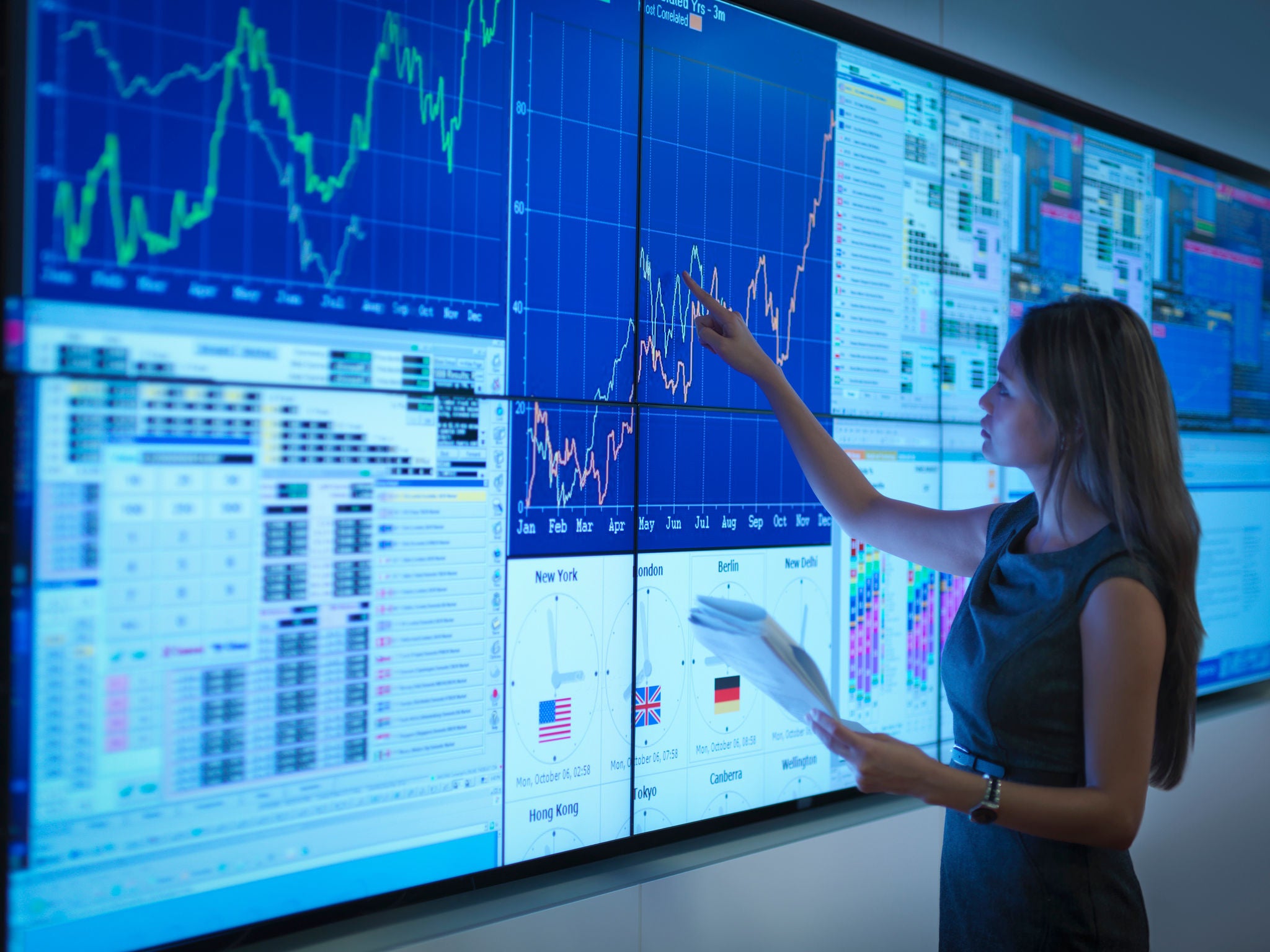 Businesswoman preparing presentation on graphical screens