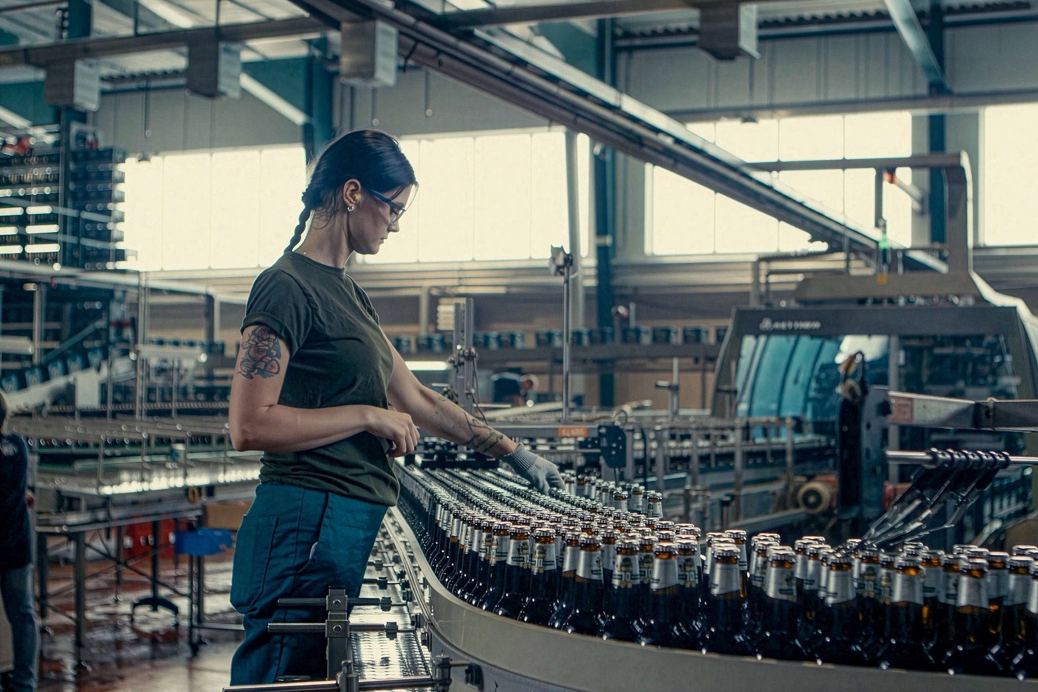 worker on the bottling line inside a brewery