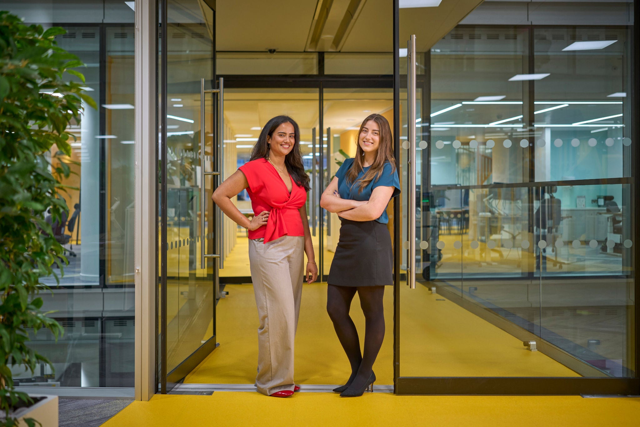 People posing at glass office doorway