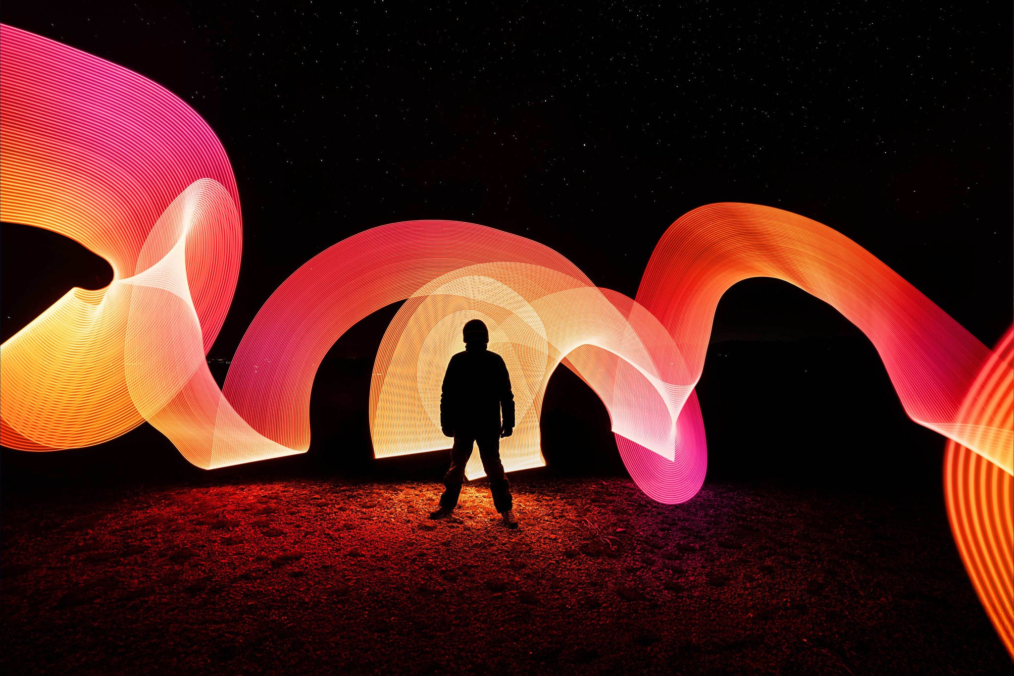 Person light painting with milky way in the background 