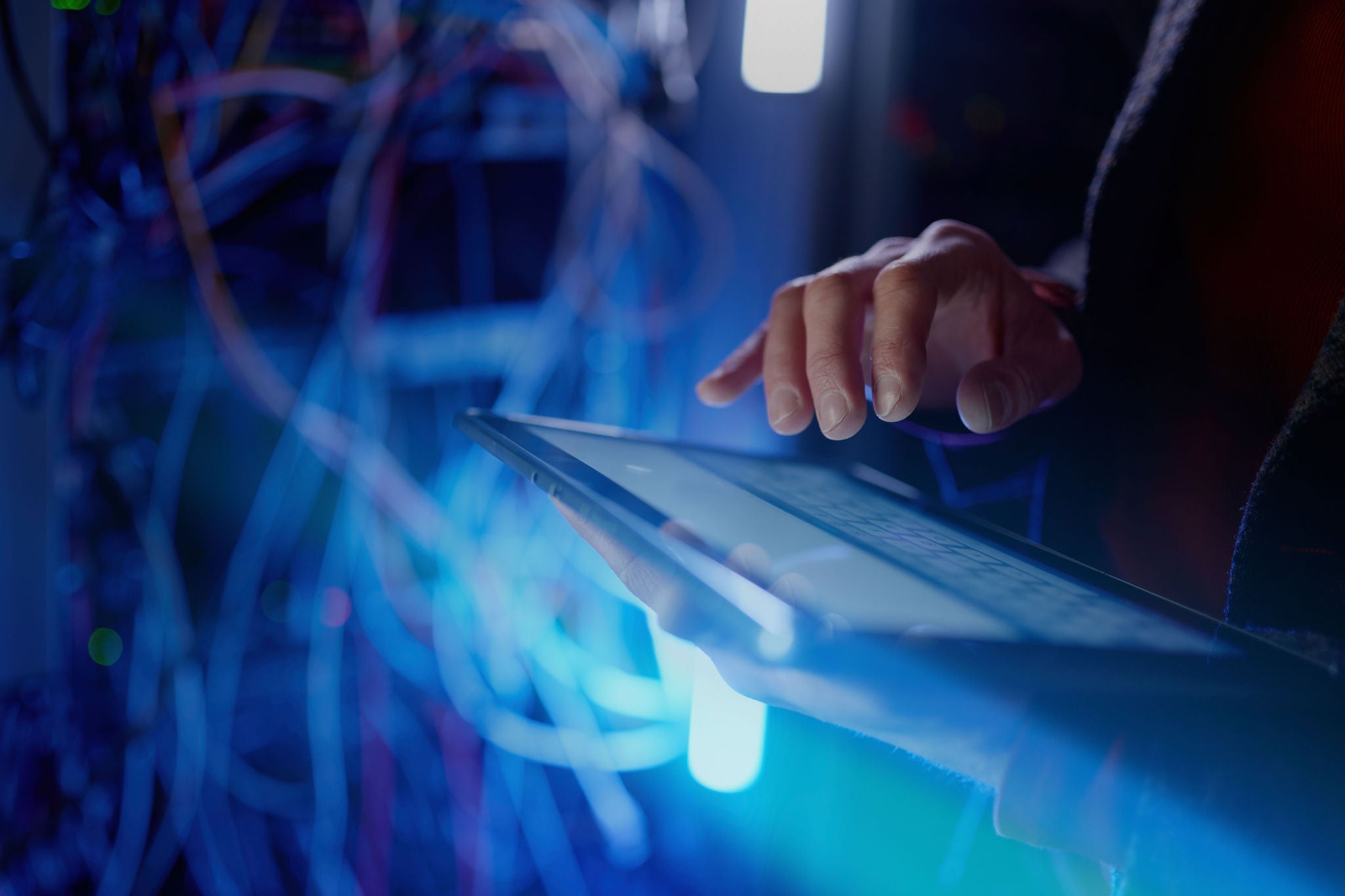 Technician checking server equipment in a data center rack