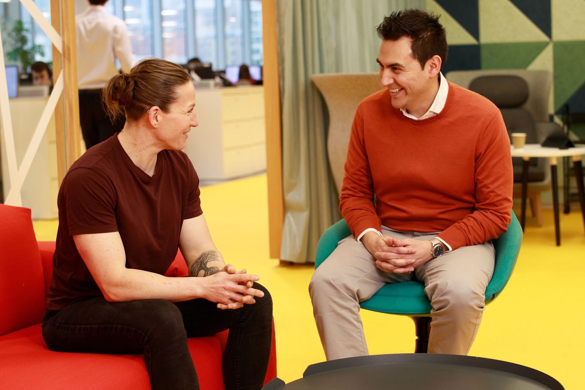 Two people sitting down and talking