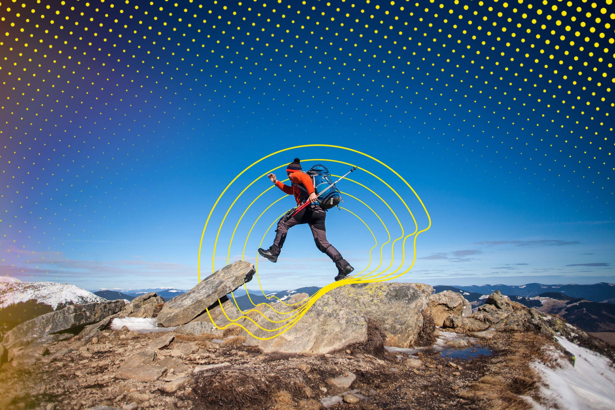 Climber with a backpack on top on a Sunny day