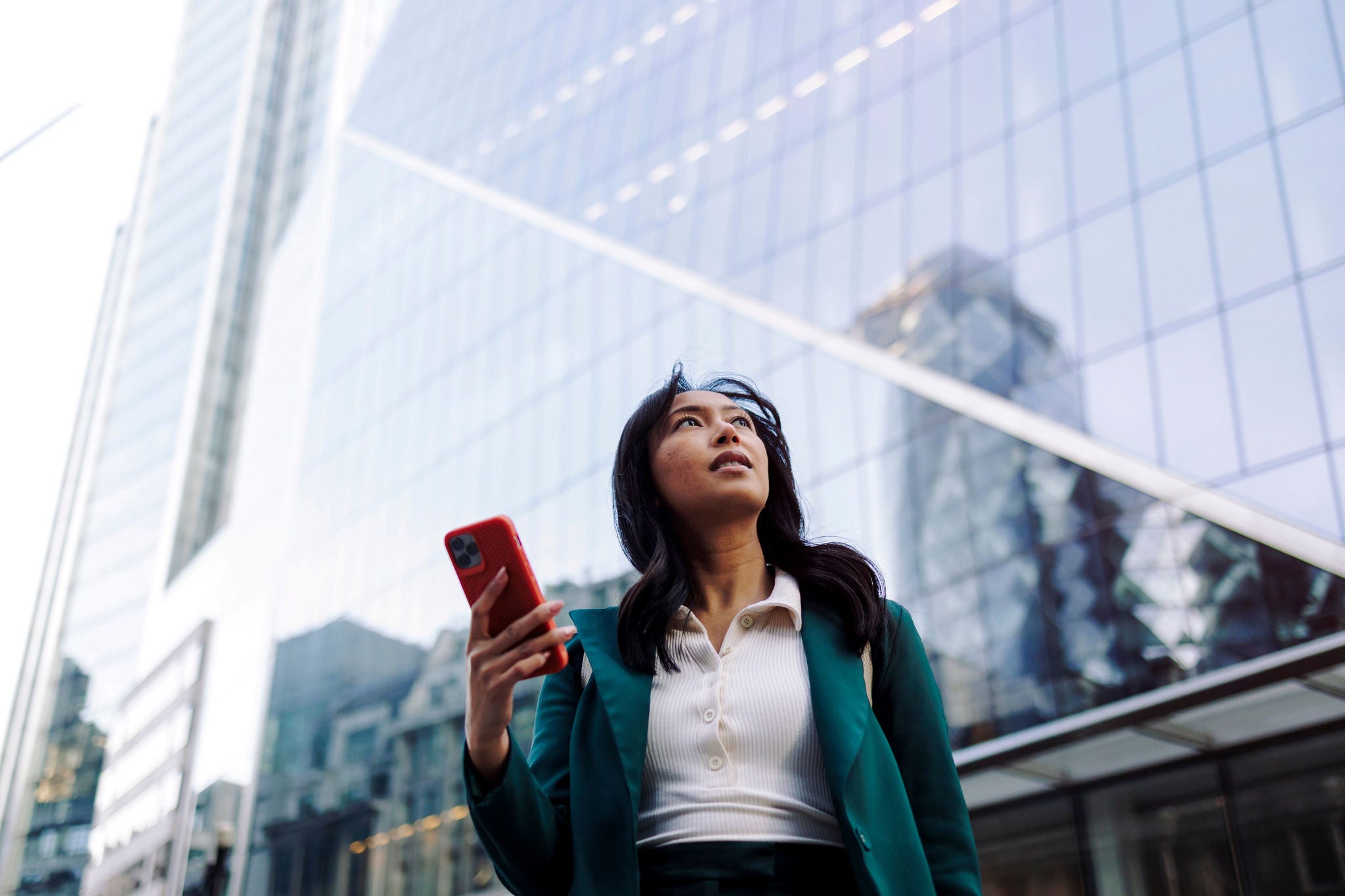 Women looking afar while holding a phone