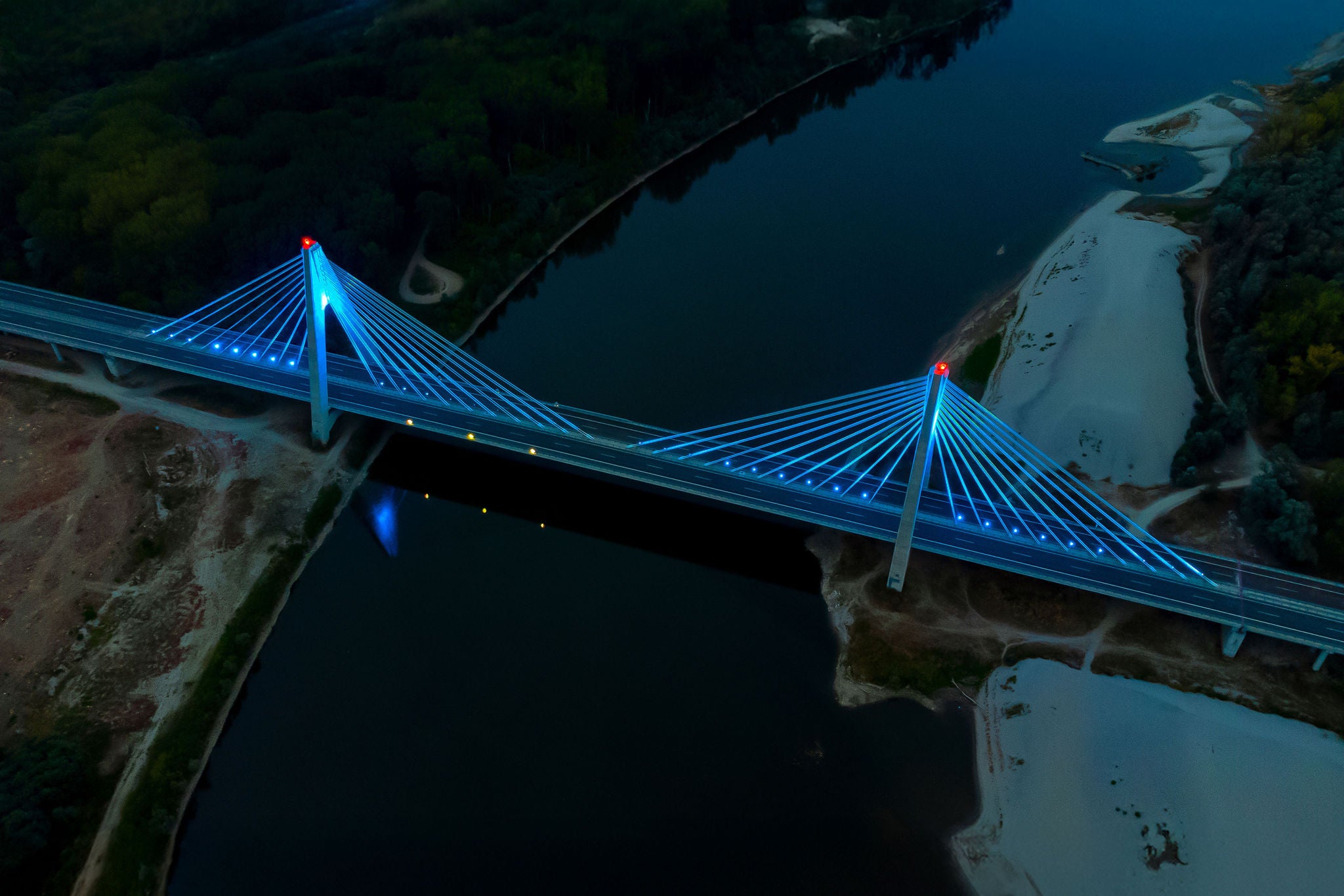 Illuminated cable stayed bridge over the dark river