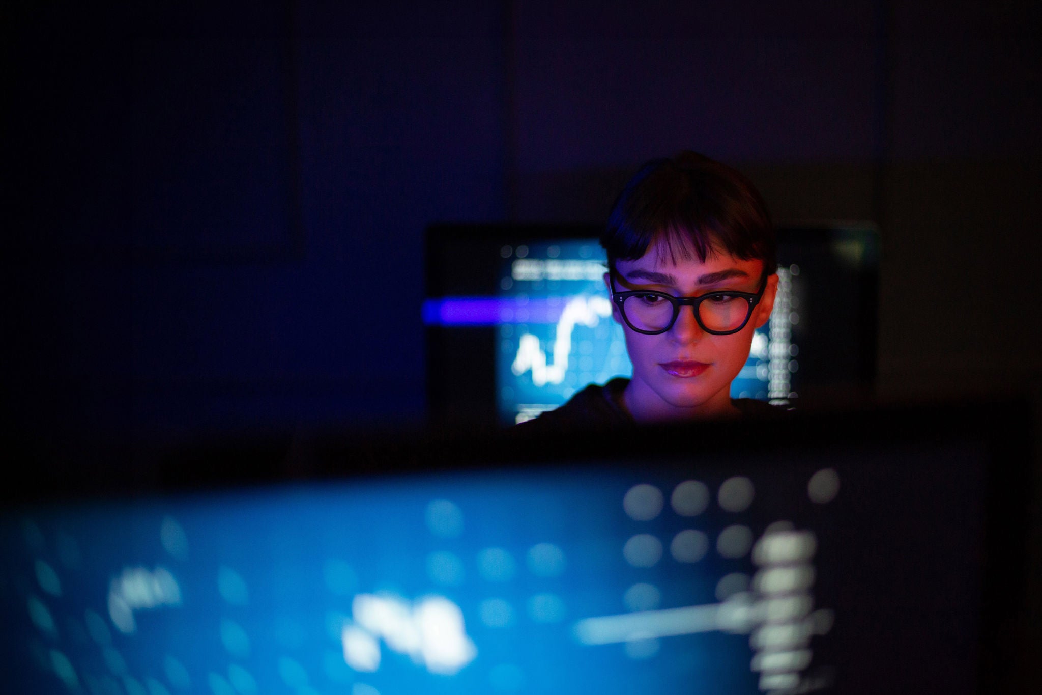Female working on a computer trading in a futuristic style