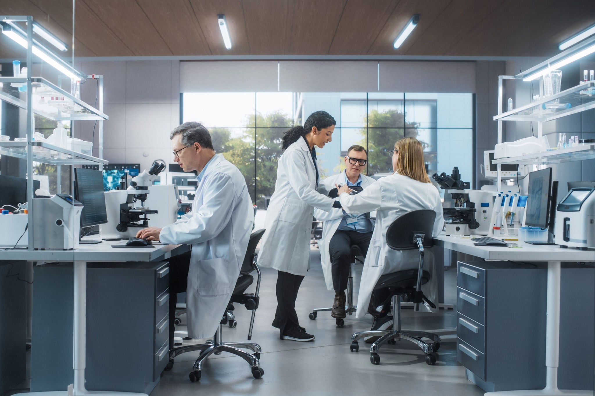 Scientifiques travaillant dans un laboratoire moderne avec microscopes