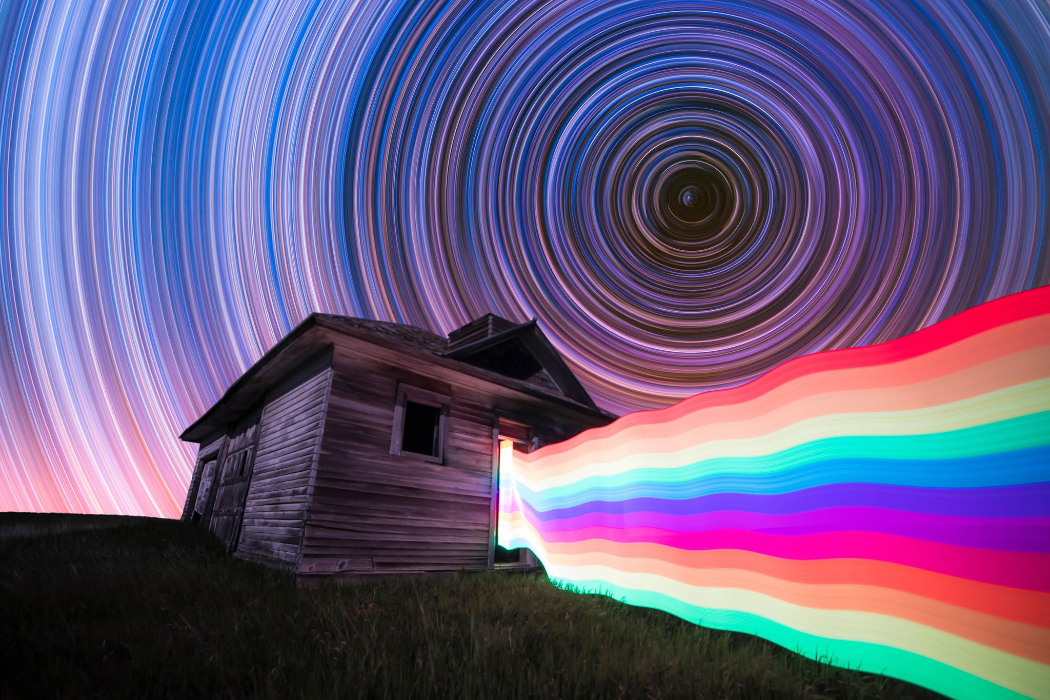 Long exposure, light painting night photography. Star trails and rainbow