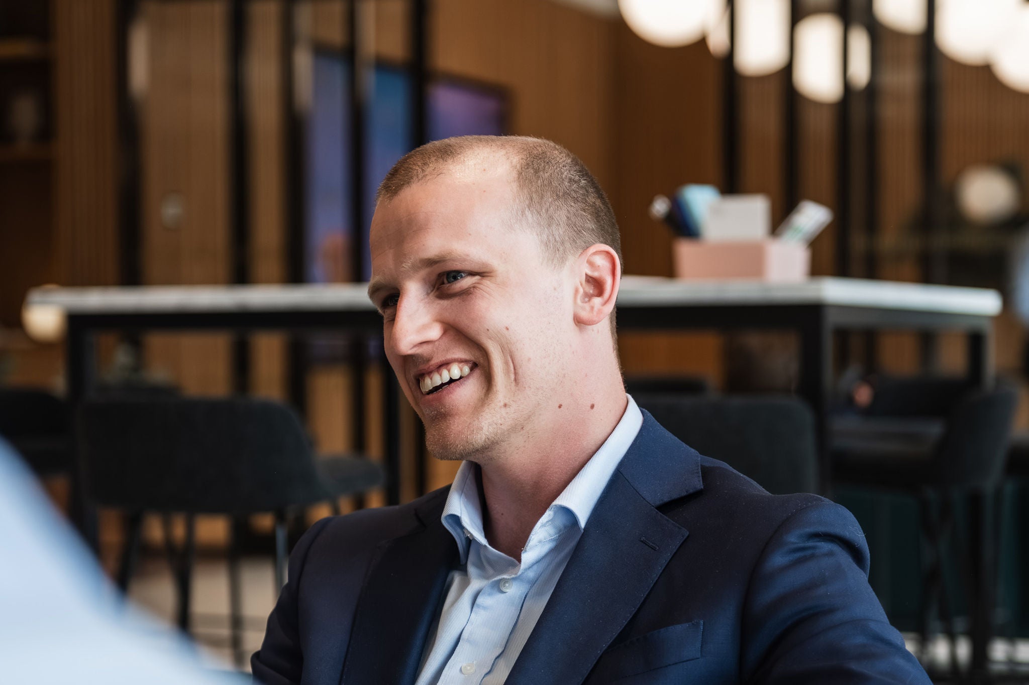 Professional engaged in conversation in a modern workplace setting