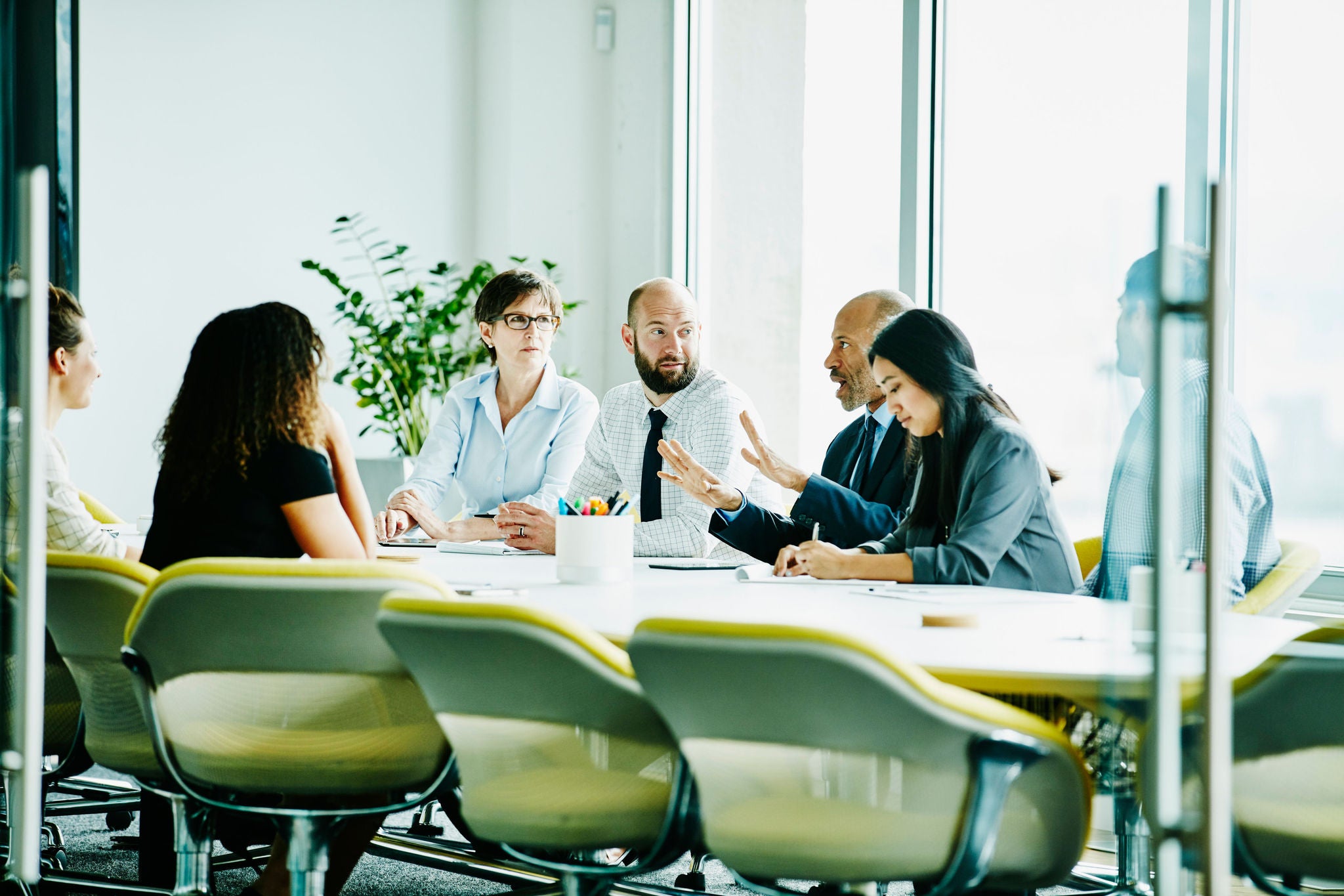 Mature businessman leading meeting in office conference room