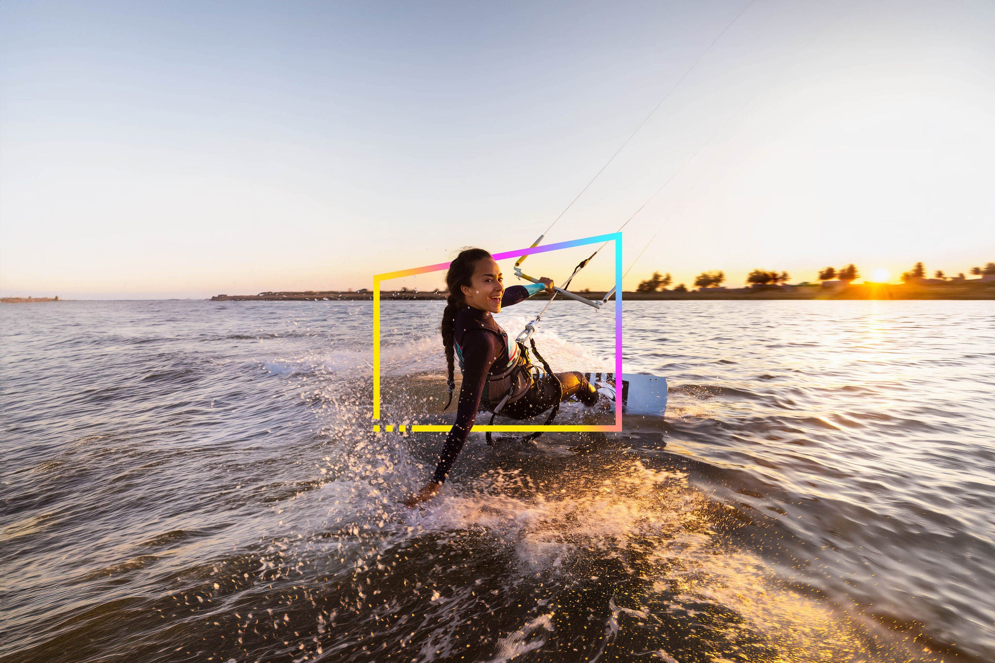 Young woman enjoying her kitesurfing success