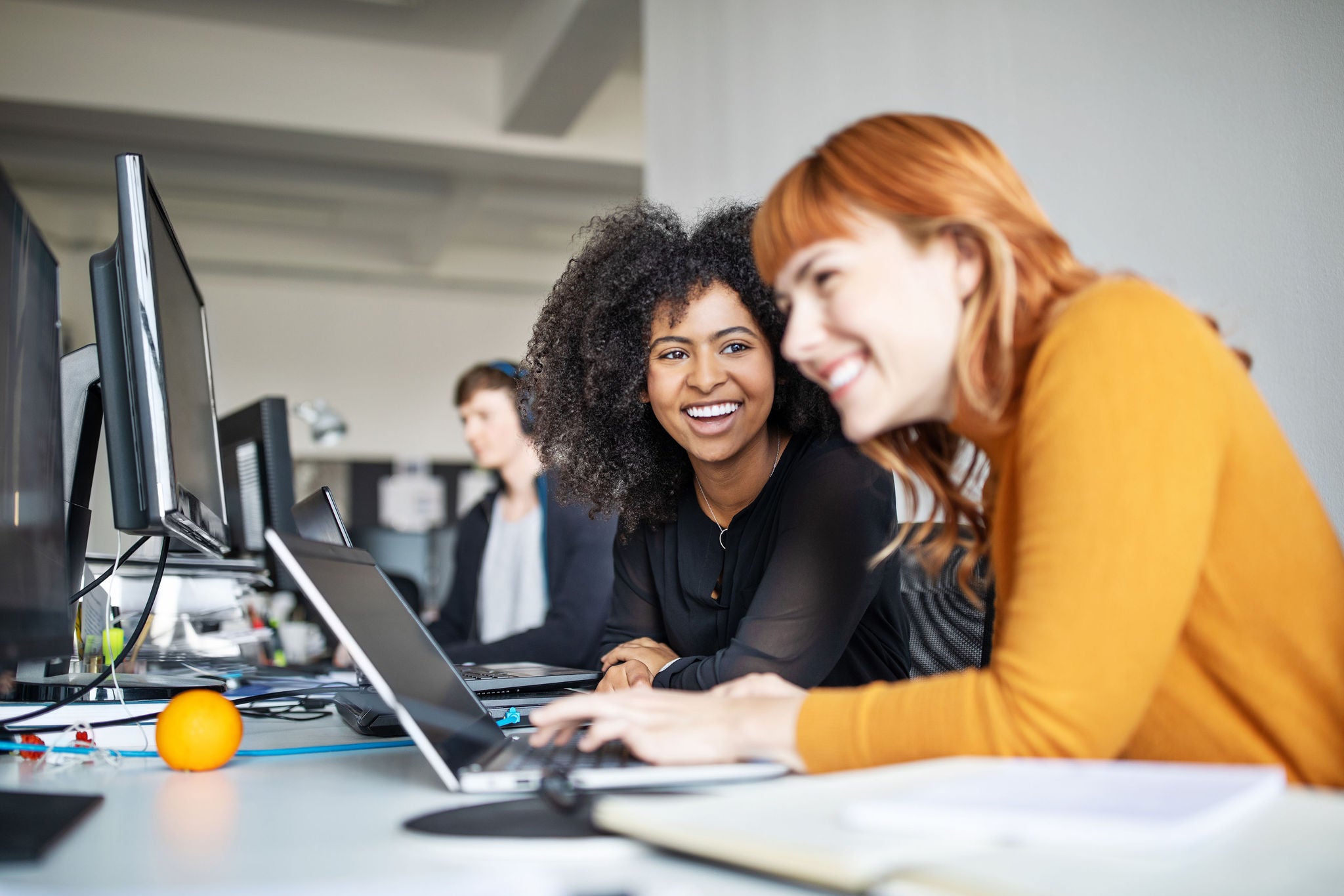 Two female colleagues in office working together
