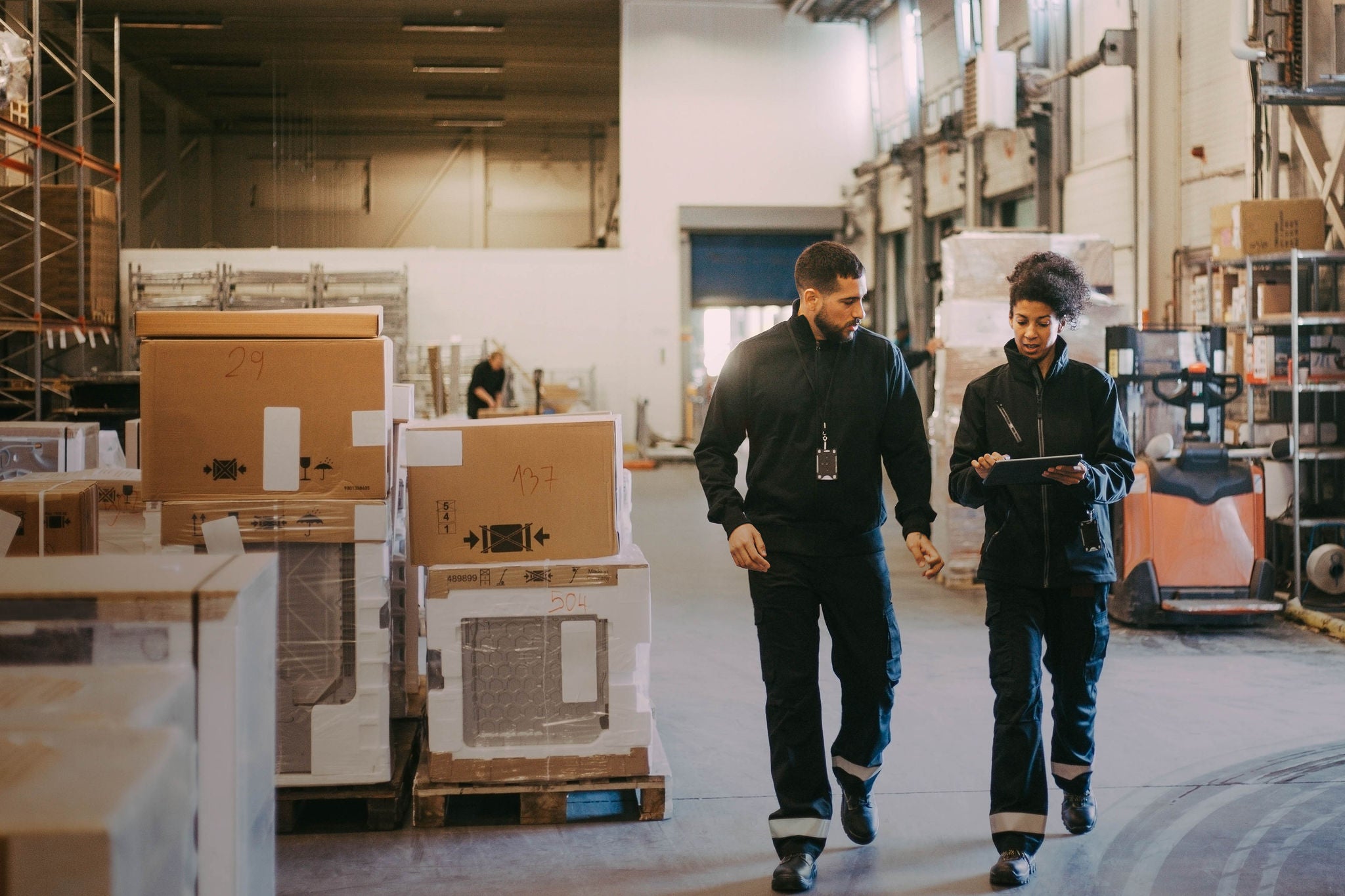 Female and male colleagues discussing at a warehouse