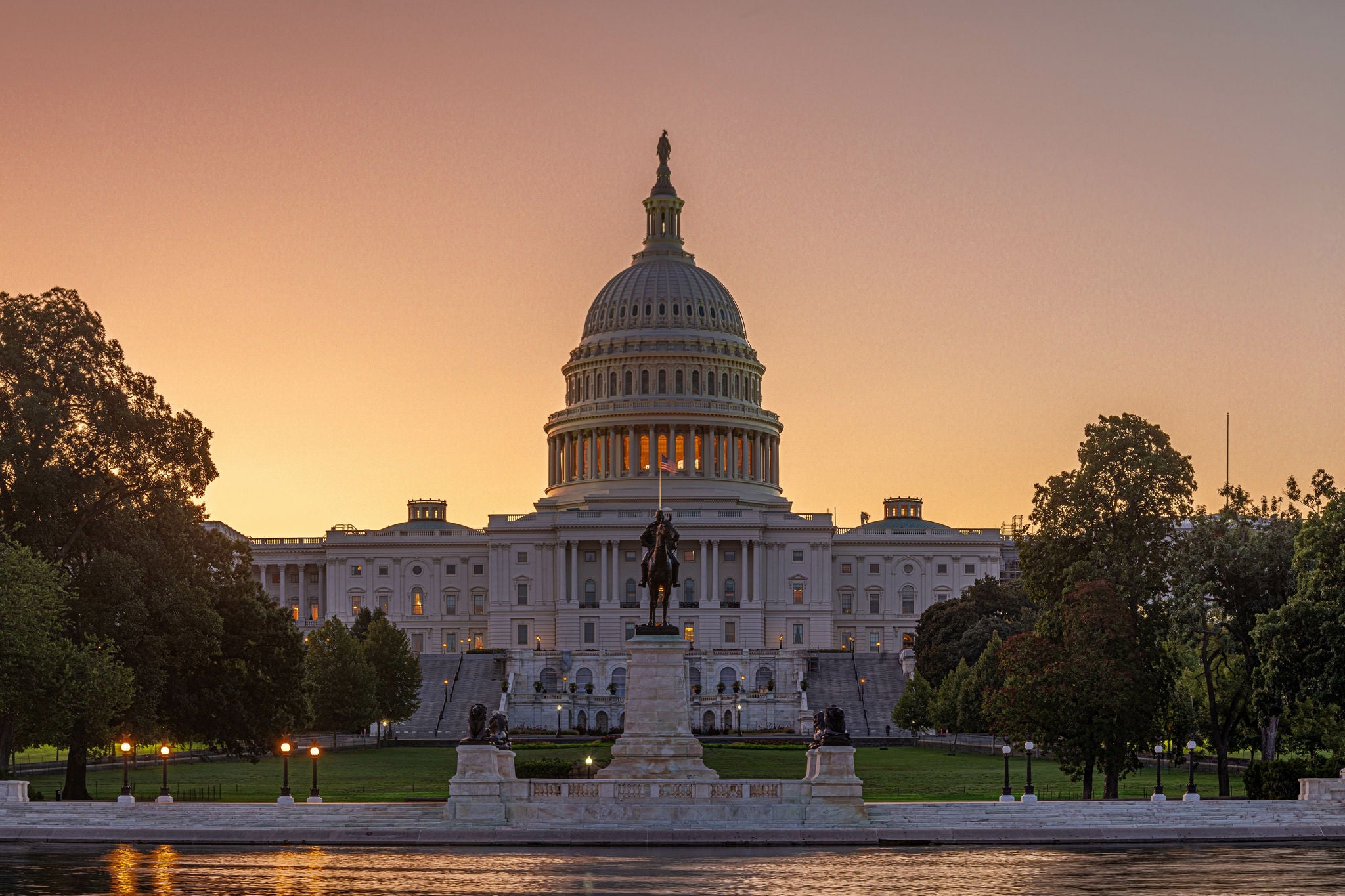 Panoramic image of the Capitol of the United States with the capitol reflecting pool in morning light.