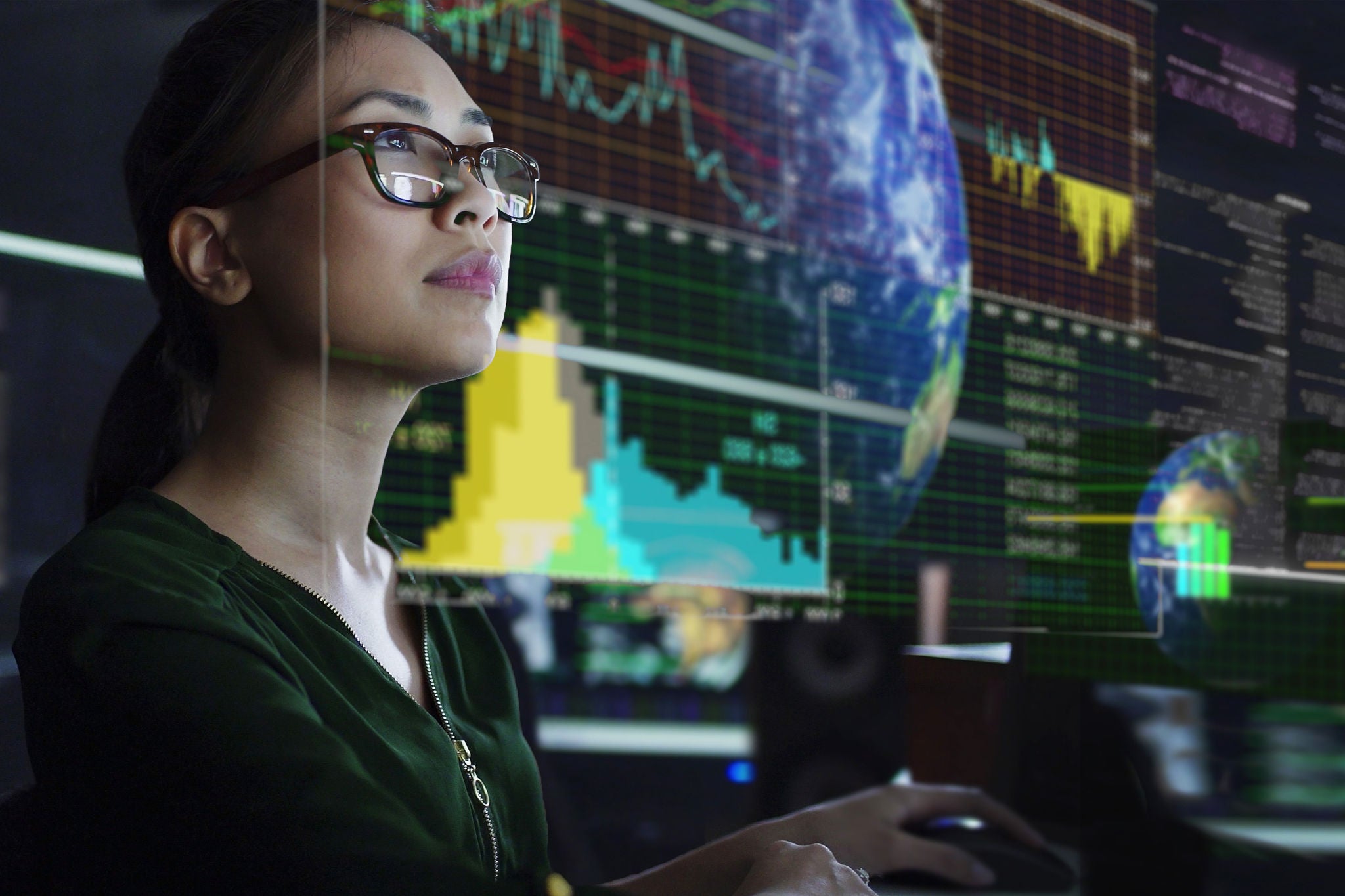 person-wearing-glasses-looking-at-multiple-digital-screens-with-colorful-financial-charts-and-graphs-using-pc-data