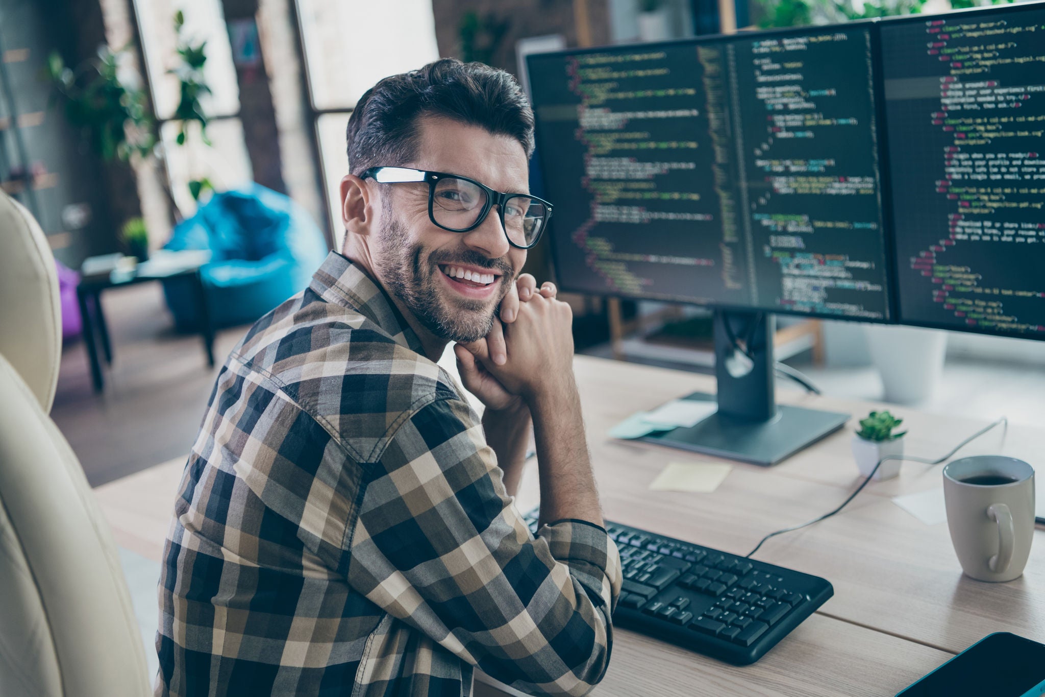 Profile portrait of cheerful intelligent web designer person sit chair create project workplace open space indoors.