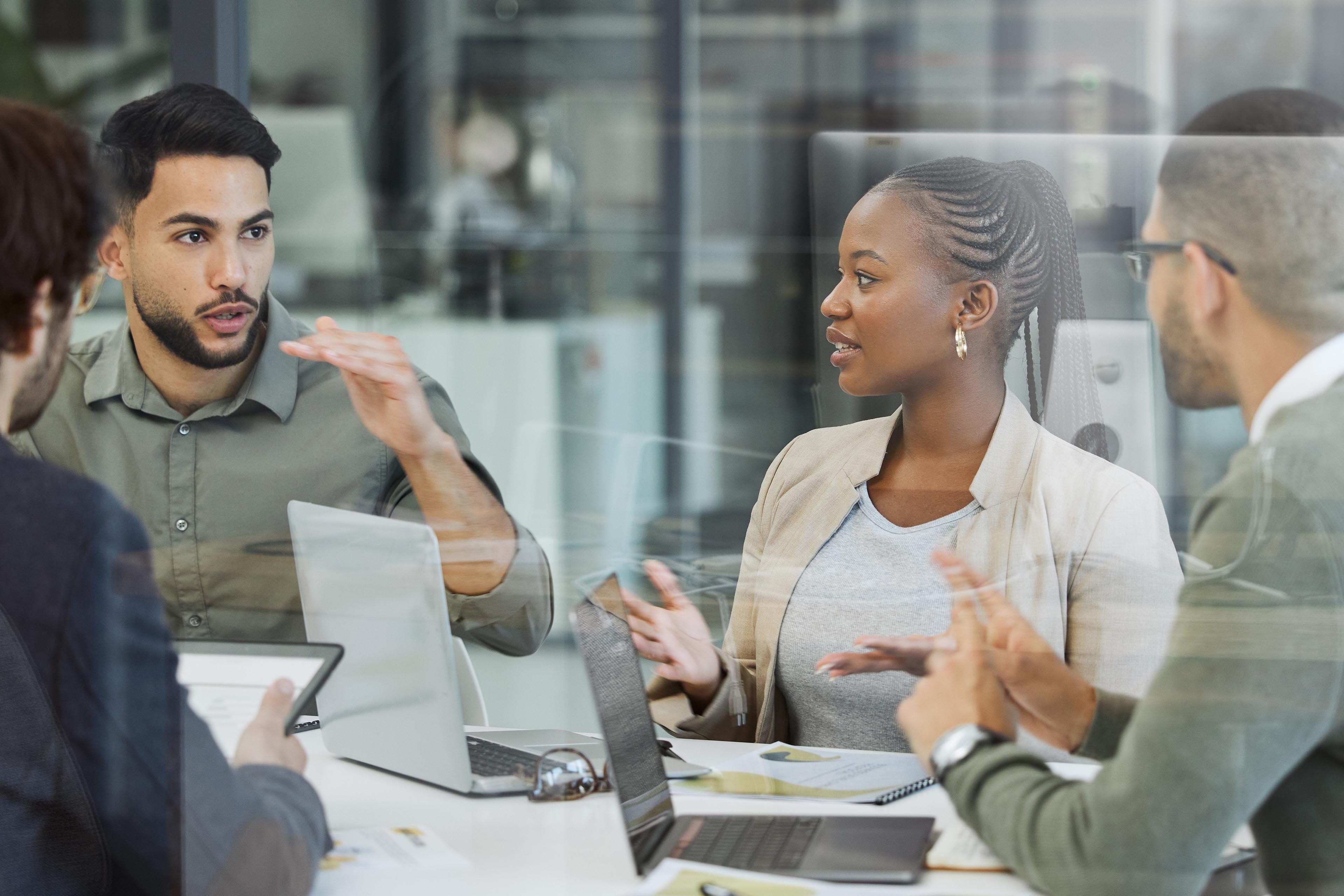Meeting, collaboration and business people in discussion in the office while working together. Teamwork, planning and group of employees brainstorming with technology for a project in the workplace