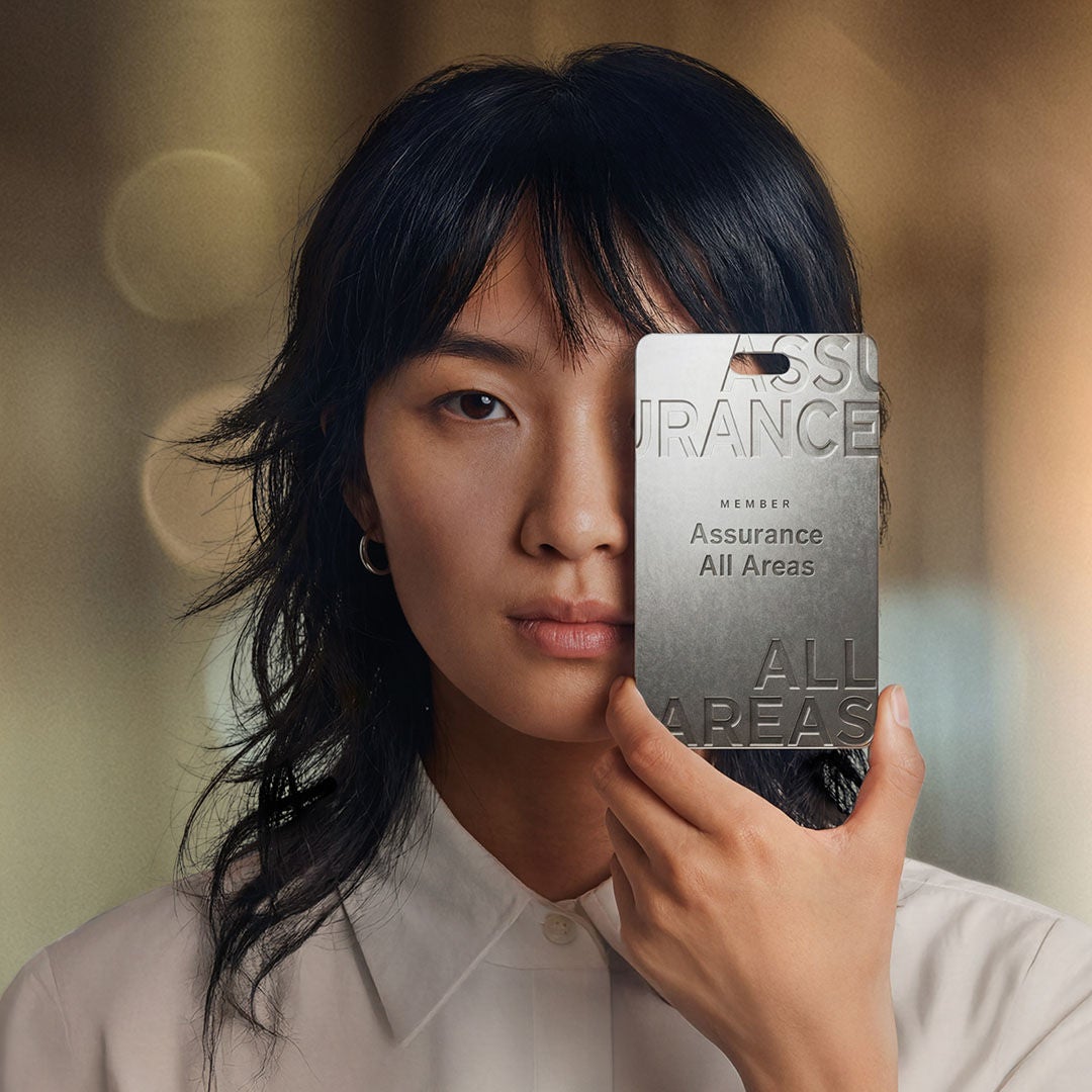 Woman shows her EY Assurance all areas pass