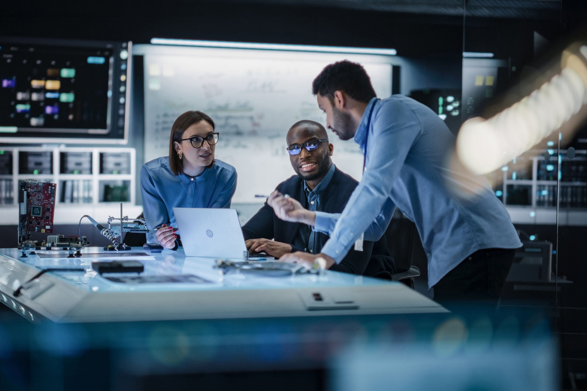 Diverse Team of Engineers Collaborating on Manufacturing Project in a Research Facility.
