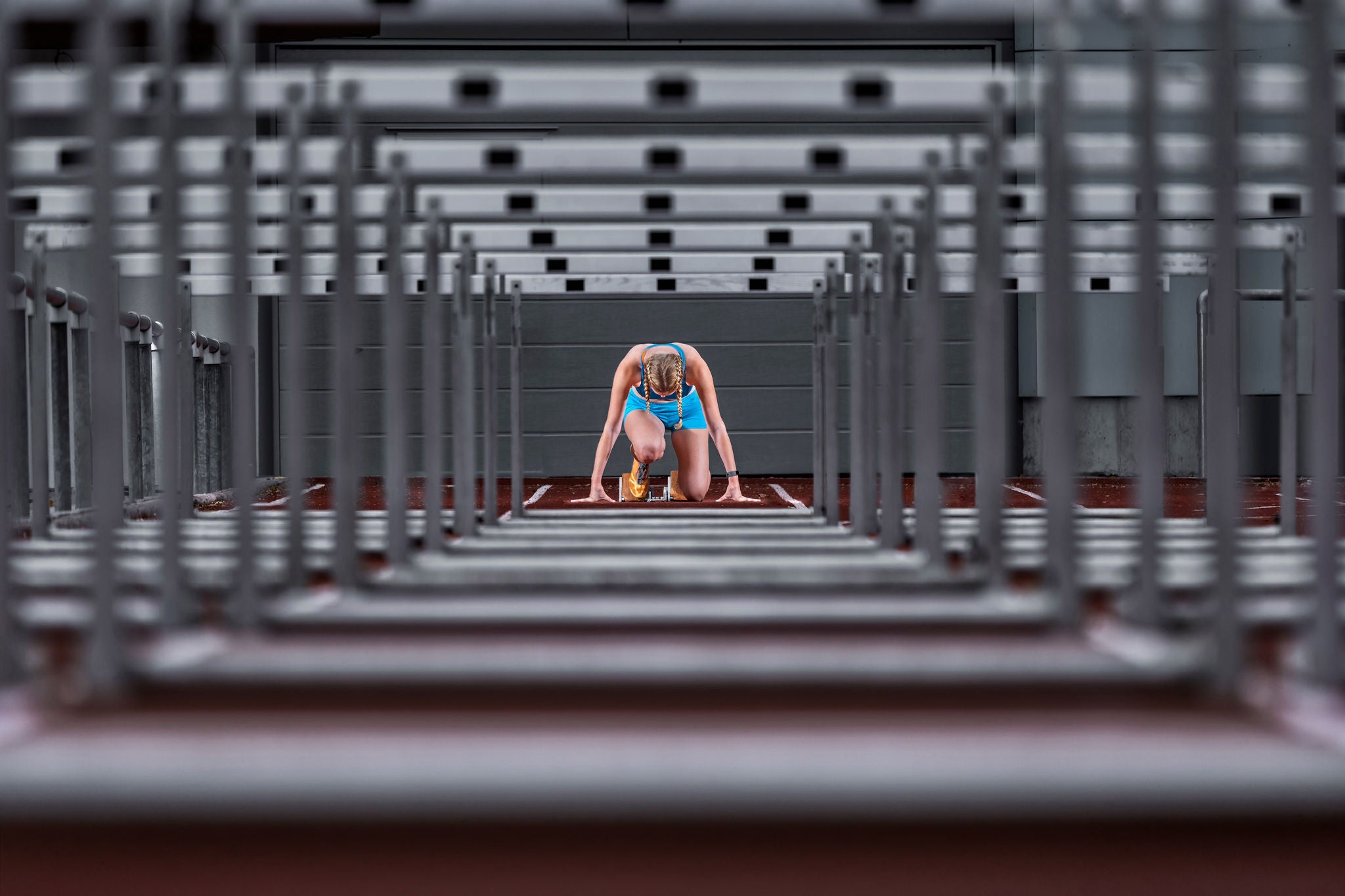 Runner in starting position on a track.