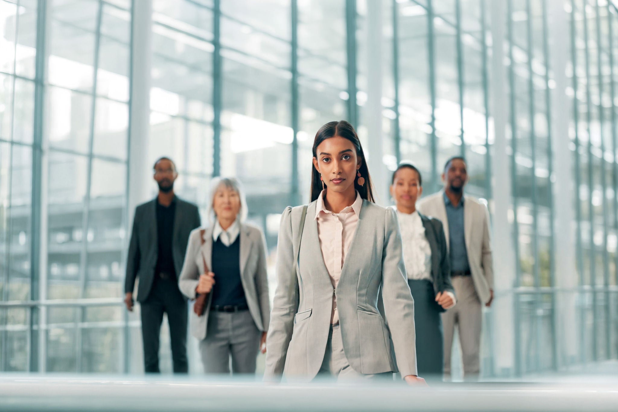 Business people in office building walking with confidence