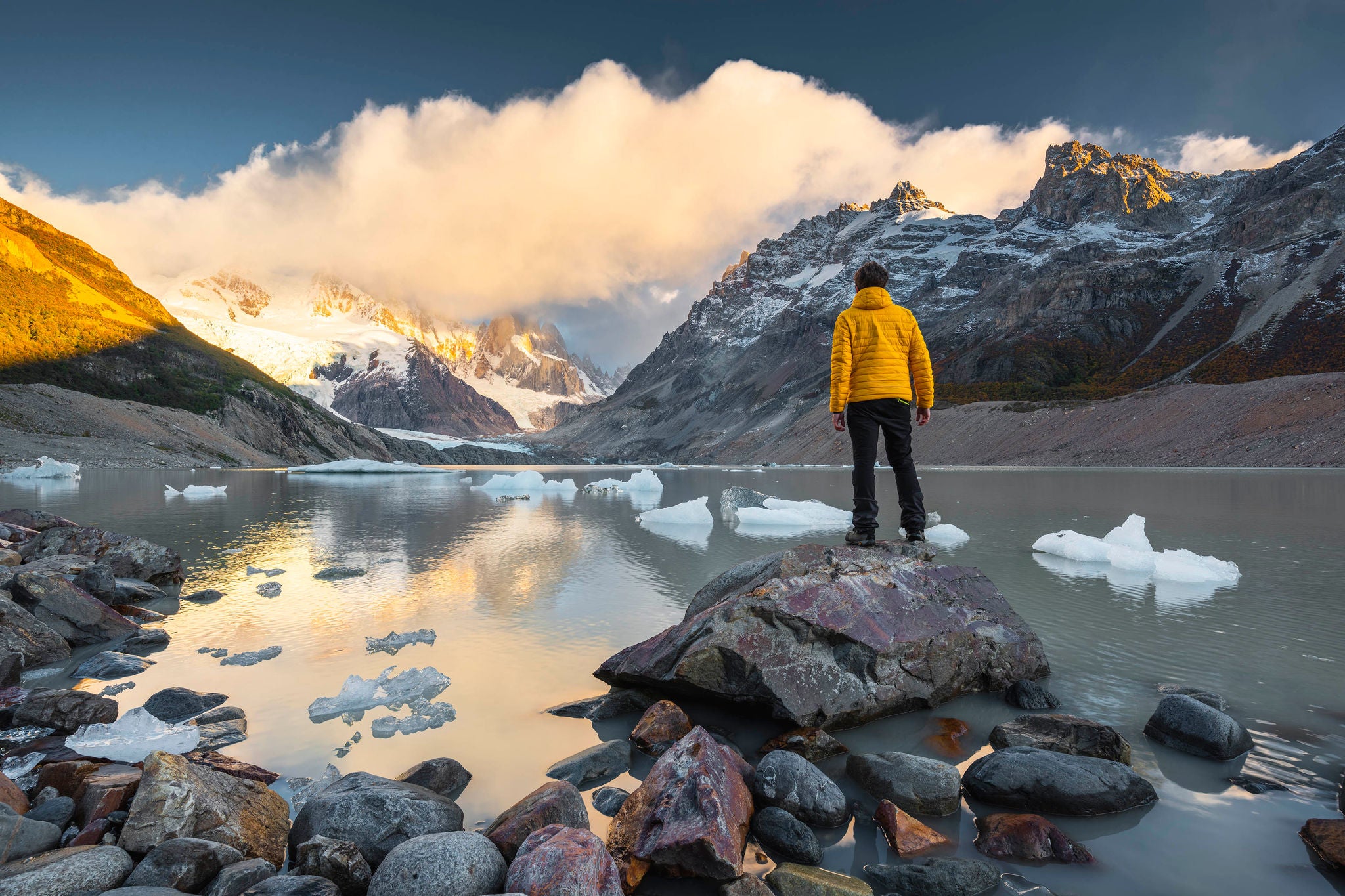 Man looking at view at sunrise in Los Glaciers national park, Argentina