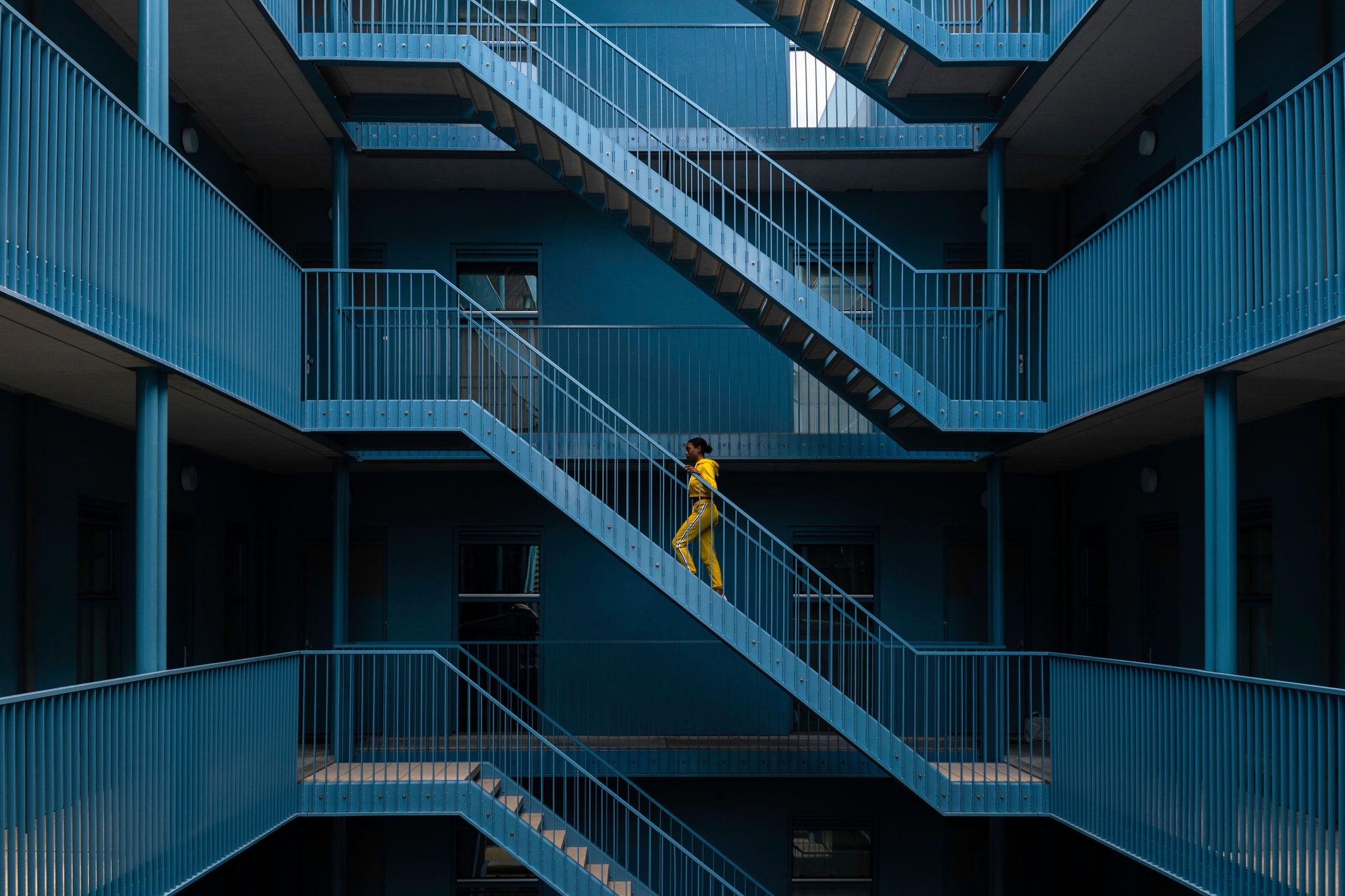 Woman yellow tracksuit Walking blue Staircase Building