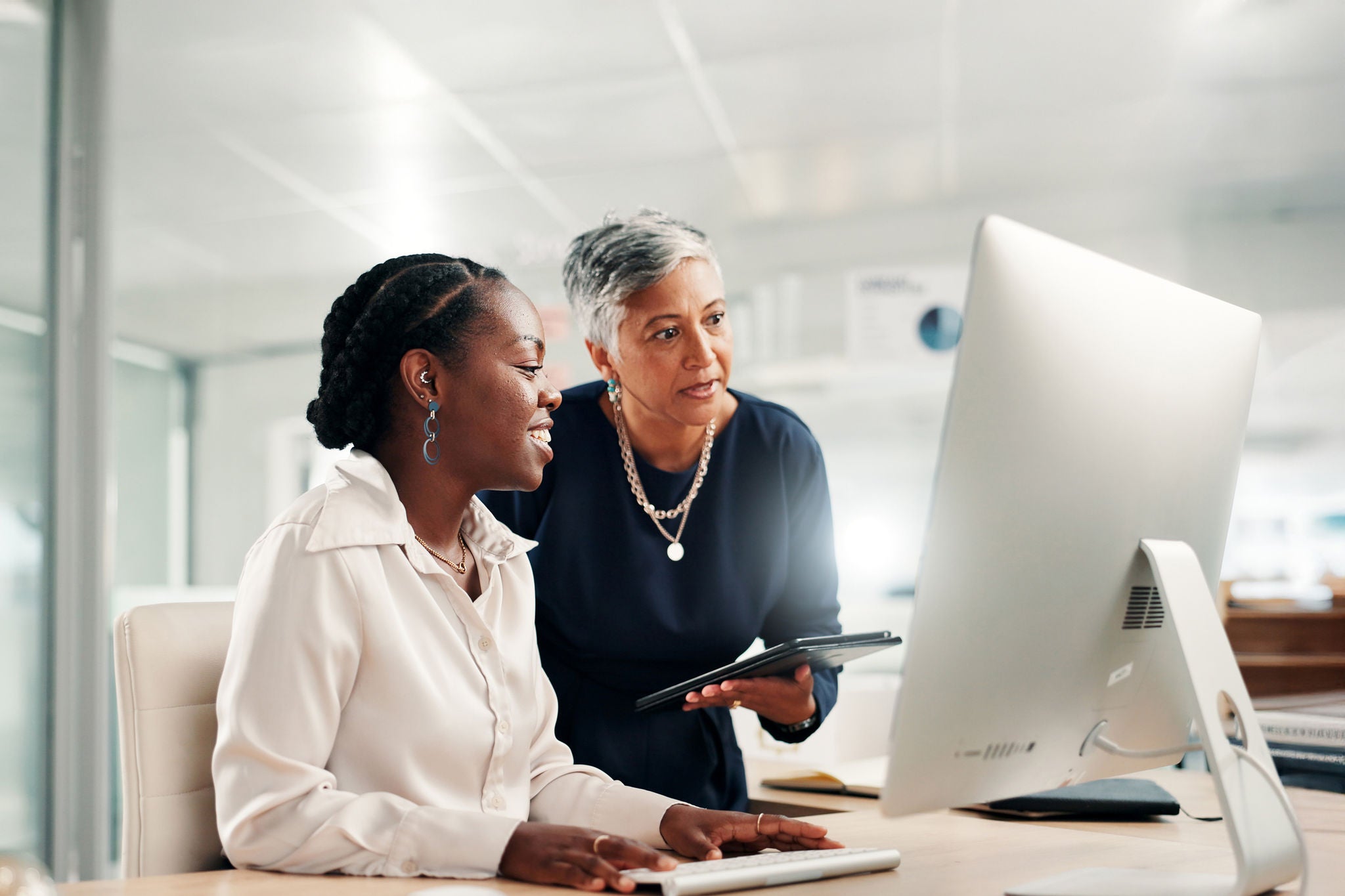 Computer, teamwork and review with business women in office for accounting discussion, audit feedback or talk. Tech, portfolio manager and collaboration with mentor, tablet and finance agency report.