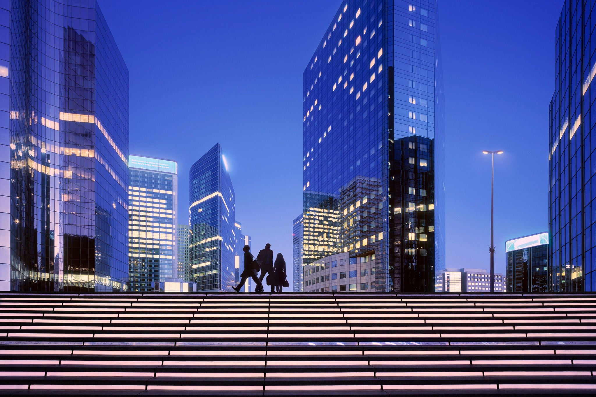 Early morning with business people arriving at modern business district