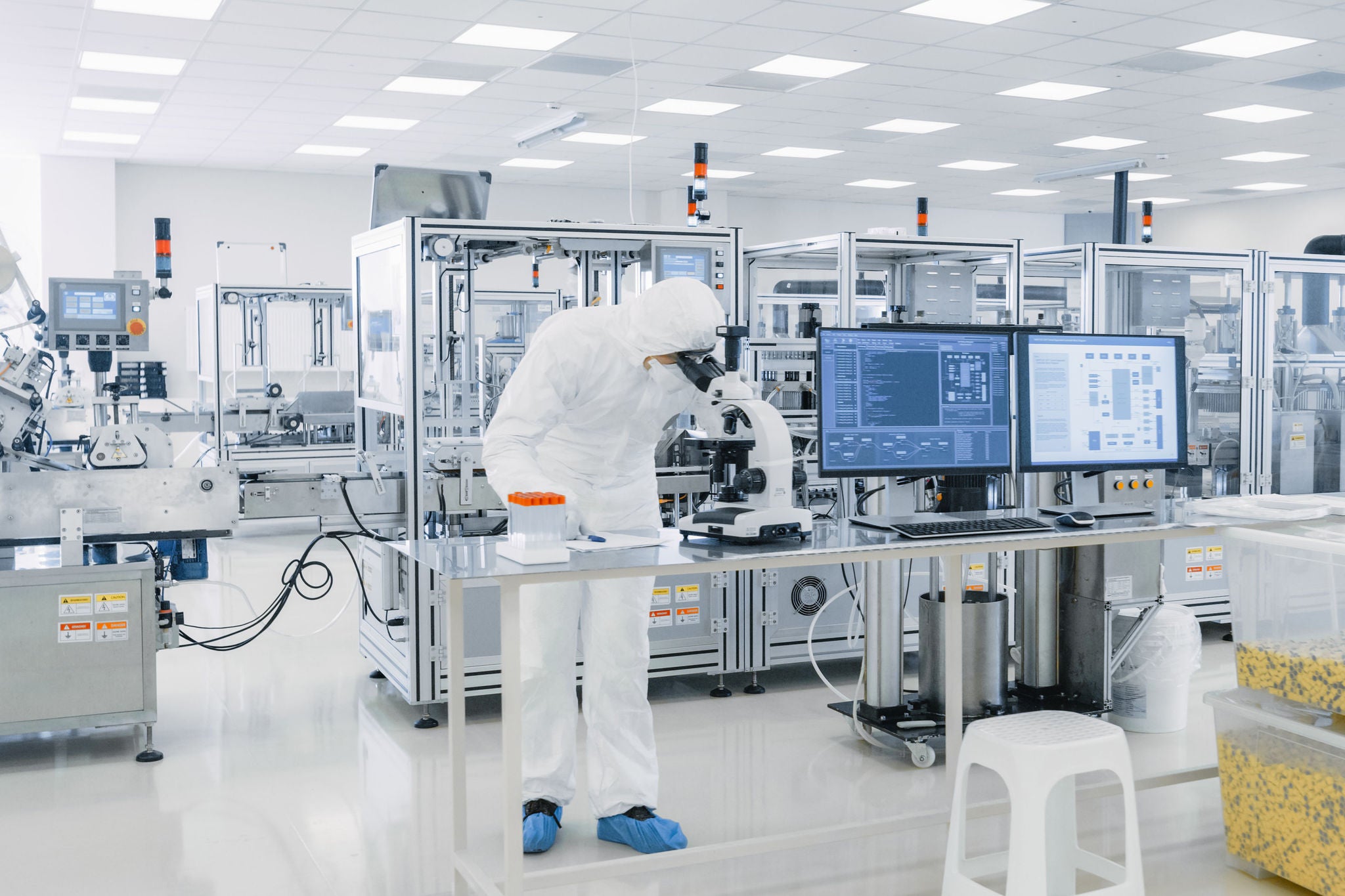 Shot of Sterile Pharmaceutical Manufacturing Laboratory where Scientists in Protective Coverall's Do Research, Quality Control and Work on the Discovery of new Medicine.; Shutterstock ID 1268263657; charge: 66184206; job: A4668 - Orifarm Case Study; name: Charles Brewer; email: charles.brewer@uk.ey.com