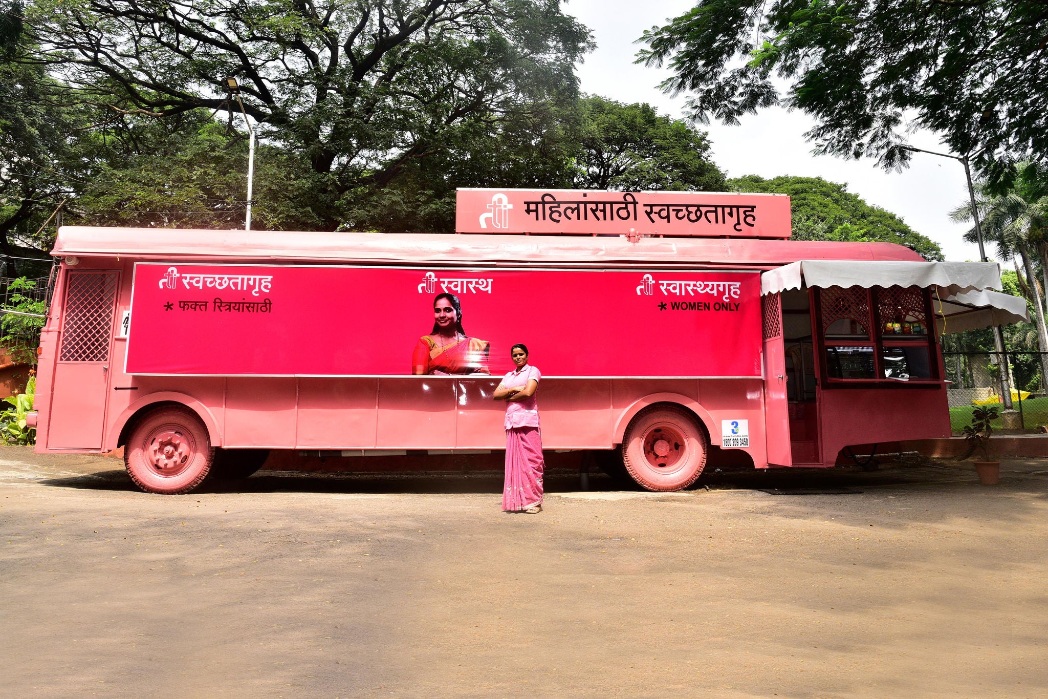 woman poses infront of the TI Bus in Pune India