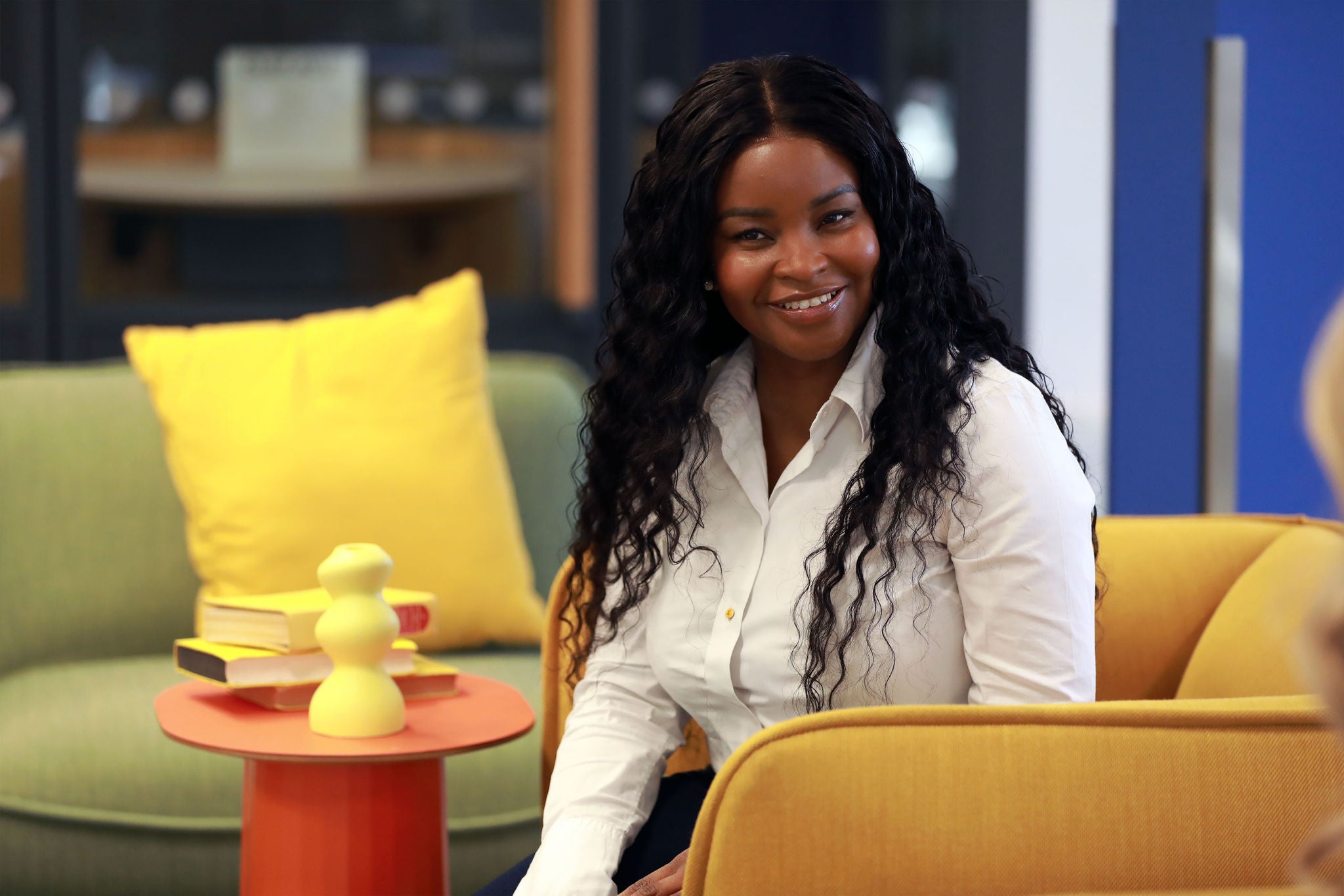 A person sitting on a yellow chair