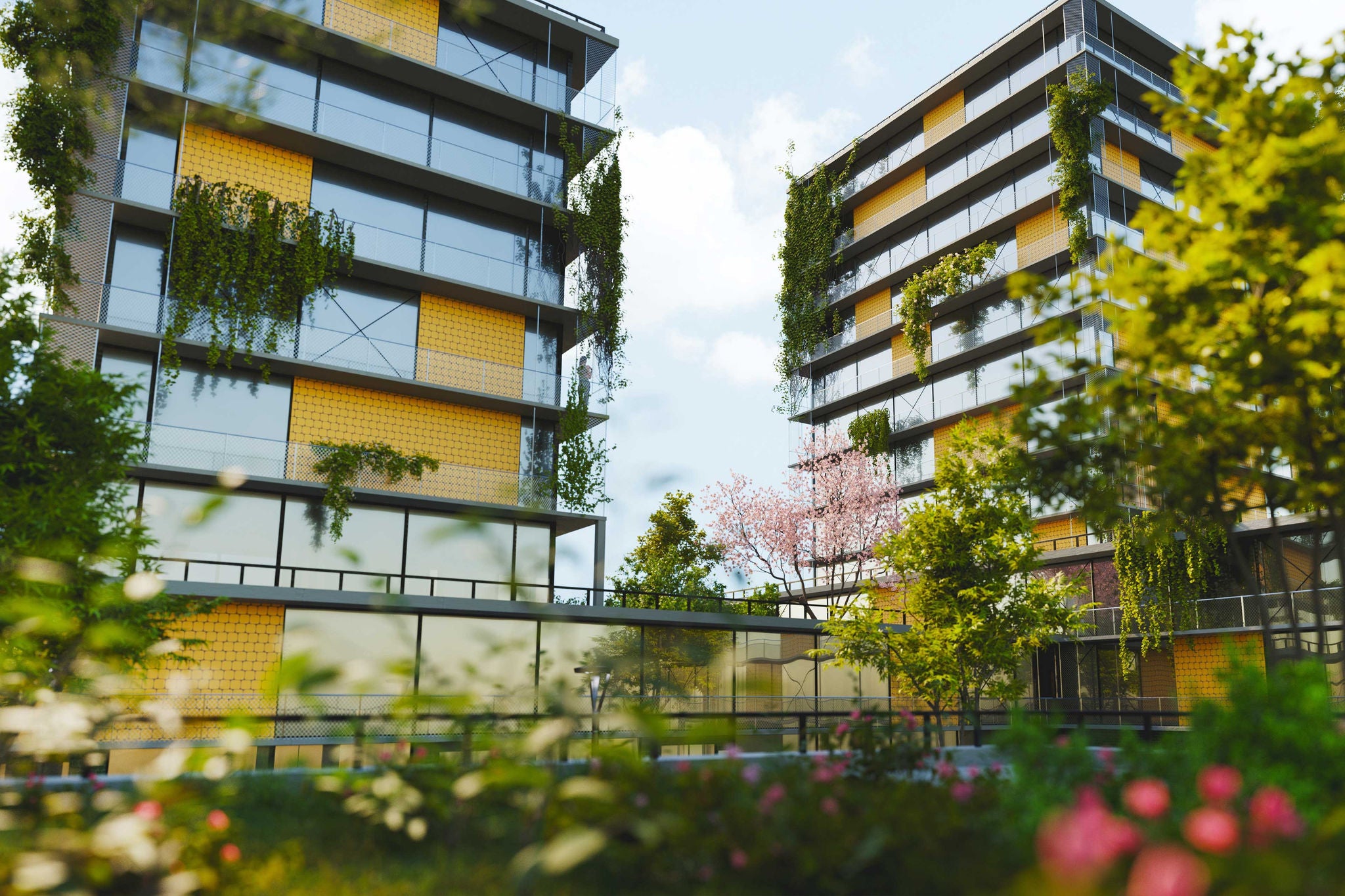 Moderne Wohngebäude mit begrünter Fassade und nachhaltiger Architektur in einer urbanen Umgebung.