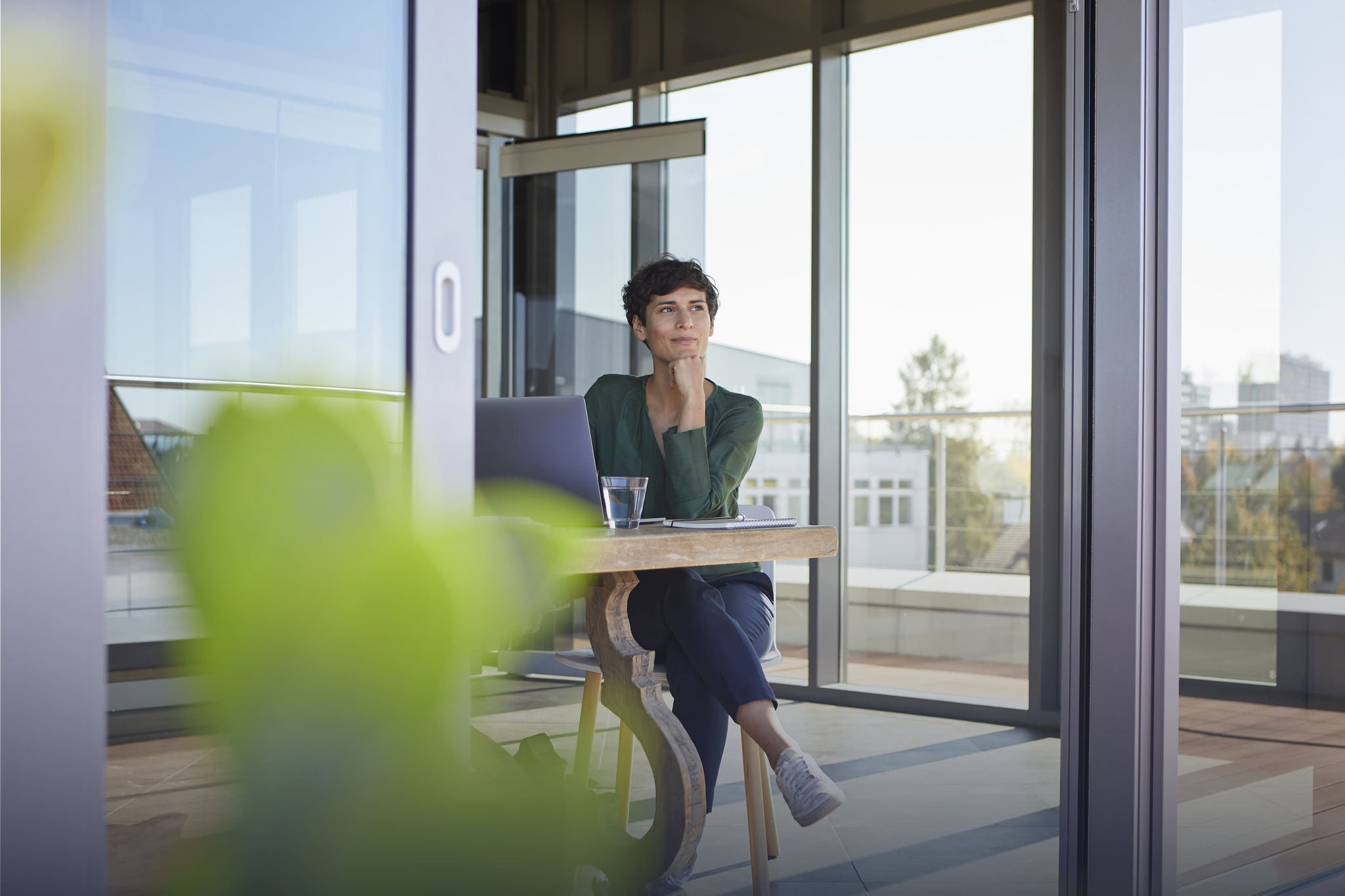 Woman working from a bright, modern workspace.