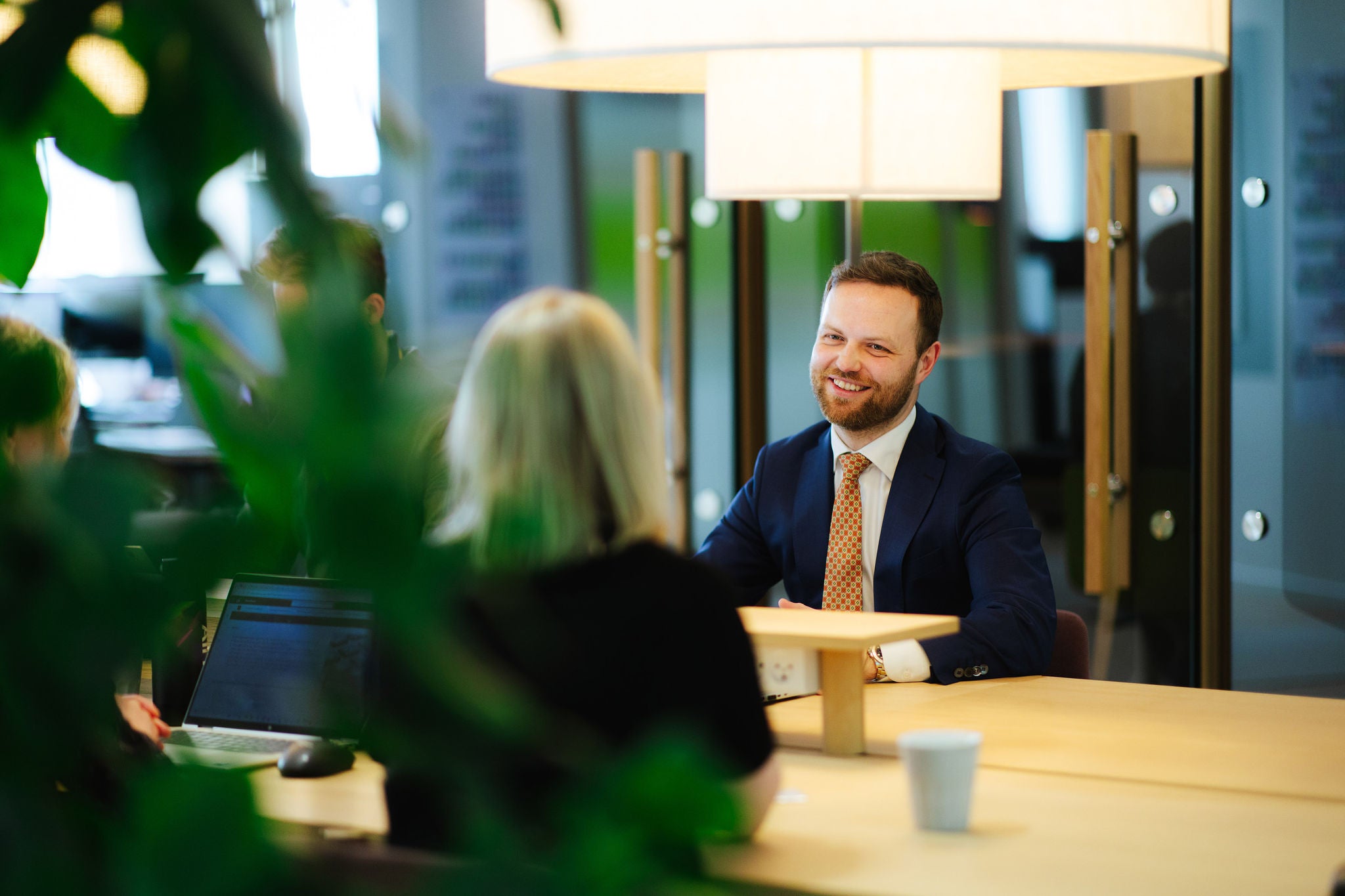 Professionals in meeting discussing work at modern office table