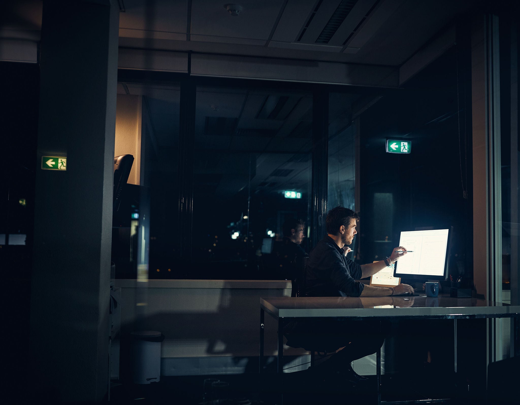 Shot of a businessman working late in an office