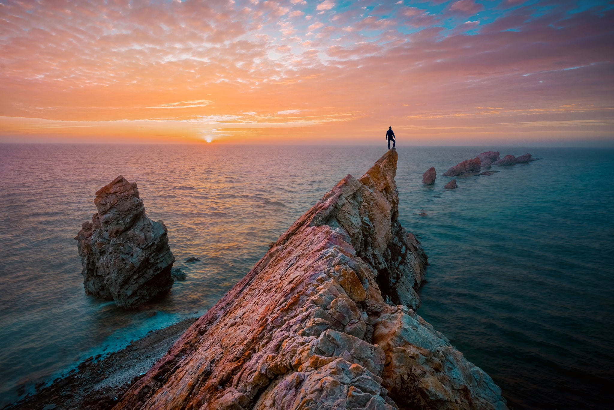 Man working on laptop while sitting in kitchen at home