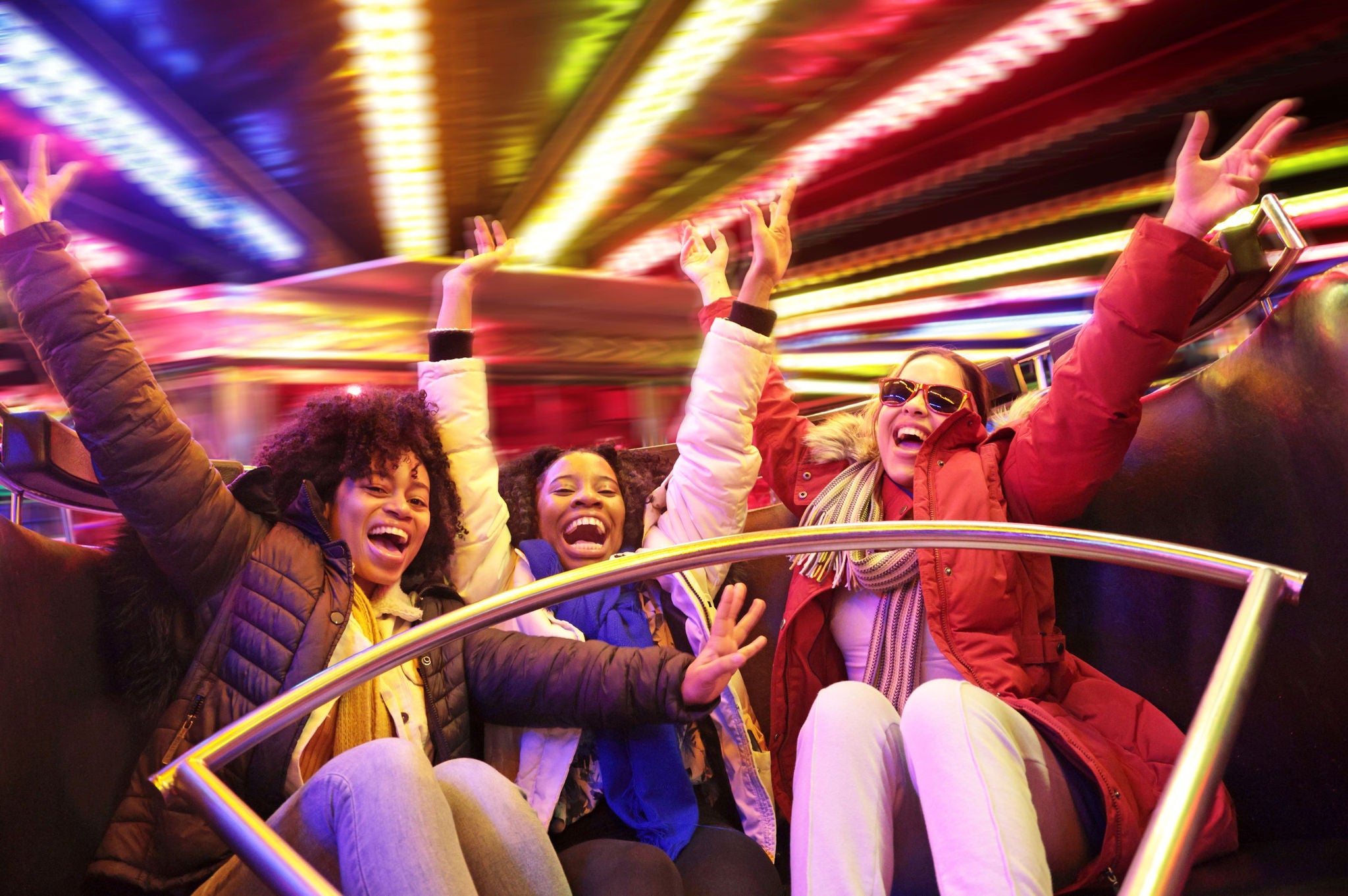 people enjoying a colorful amusement ride