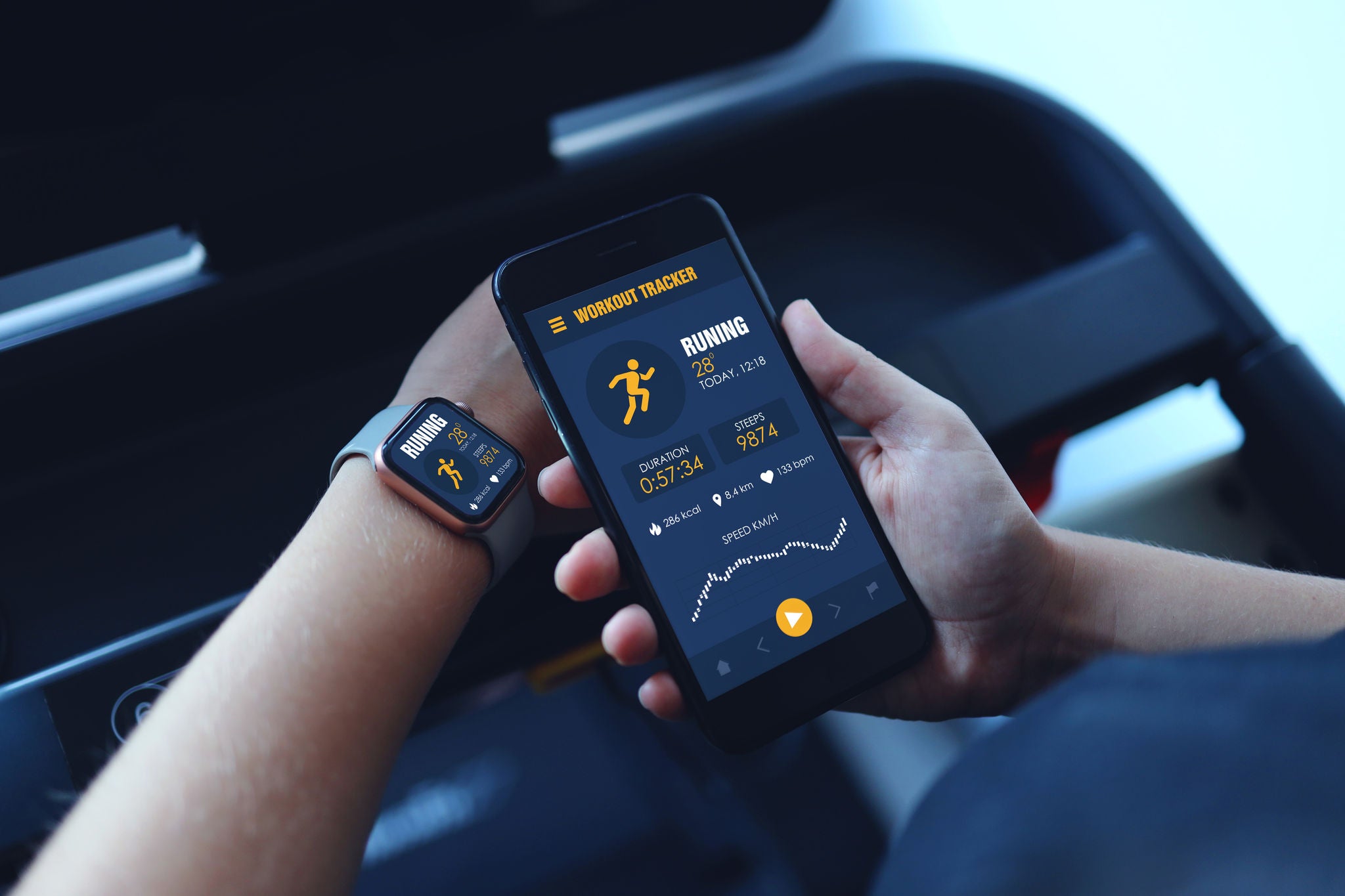 Sport woman running treadmill use smartwatch connect smartphone workout app and listening music. Indoors gym background. Health sport concept