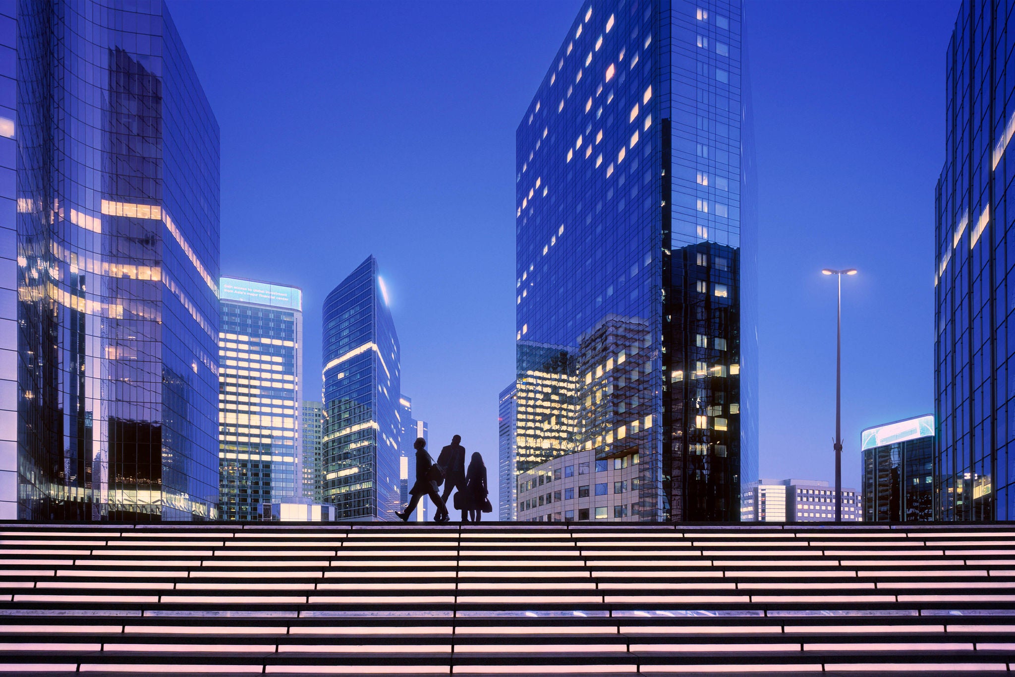 Early morning with business people arriving at modern business district