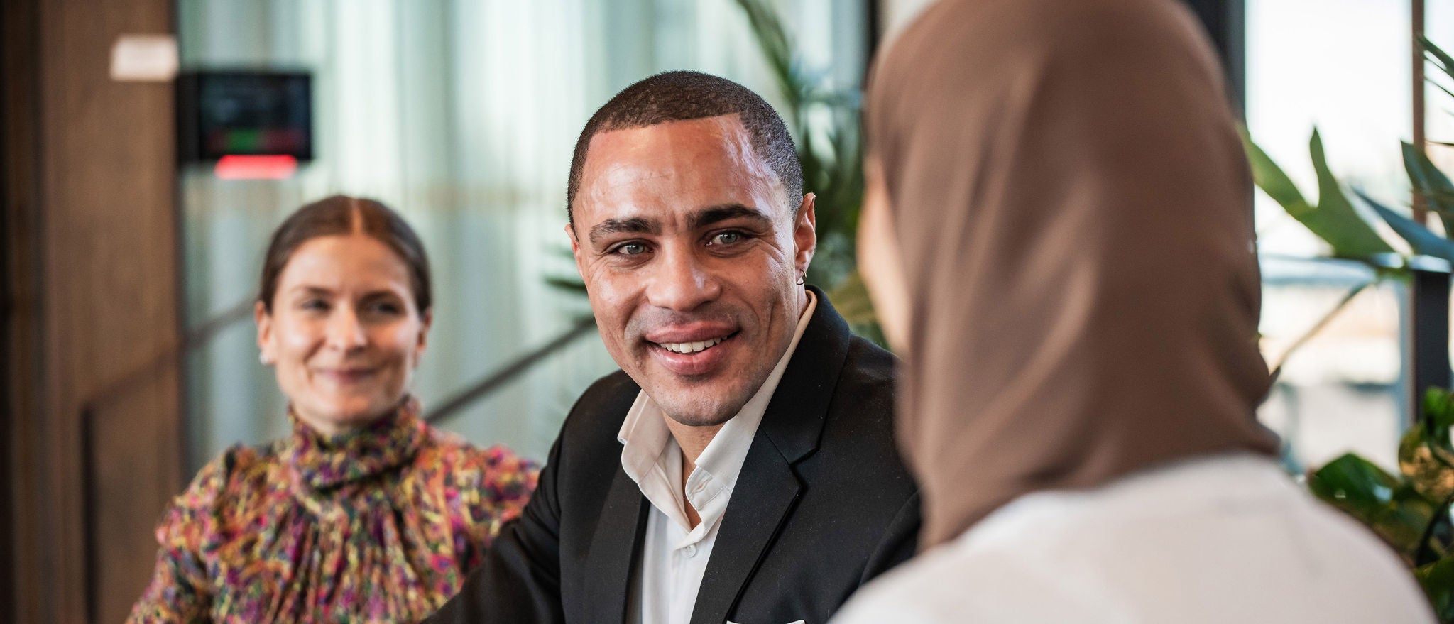 Professional networking conversation among colleagues in an office