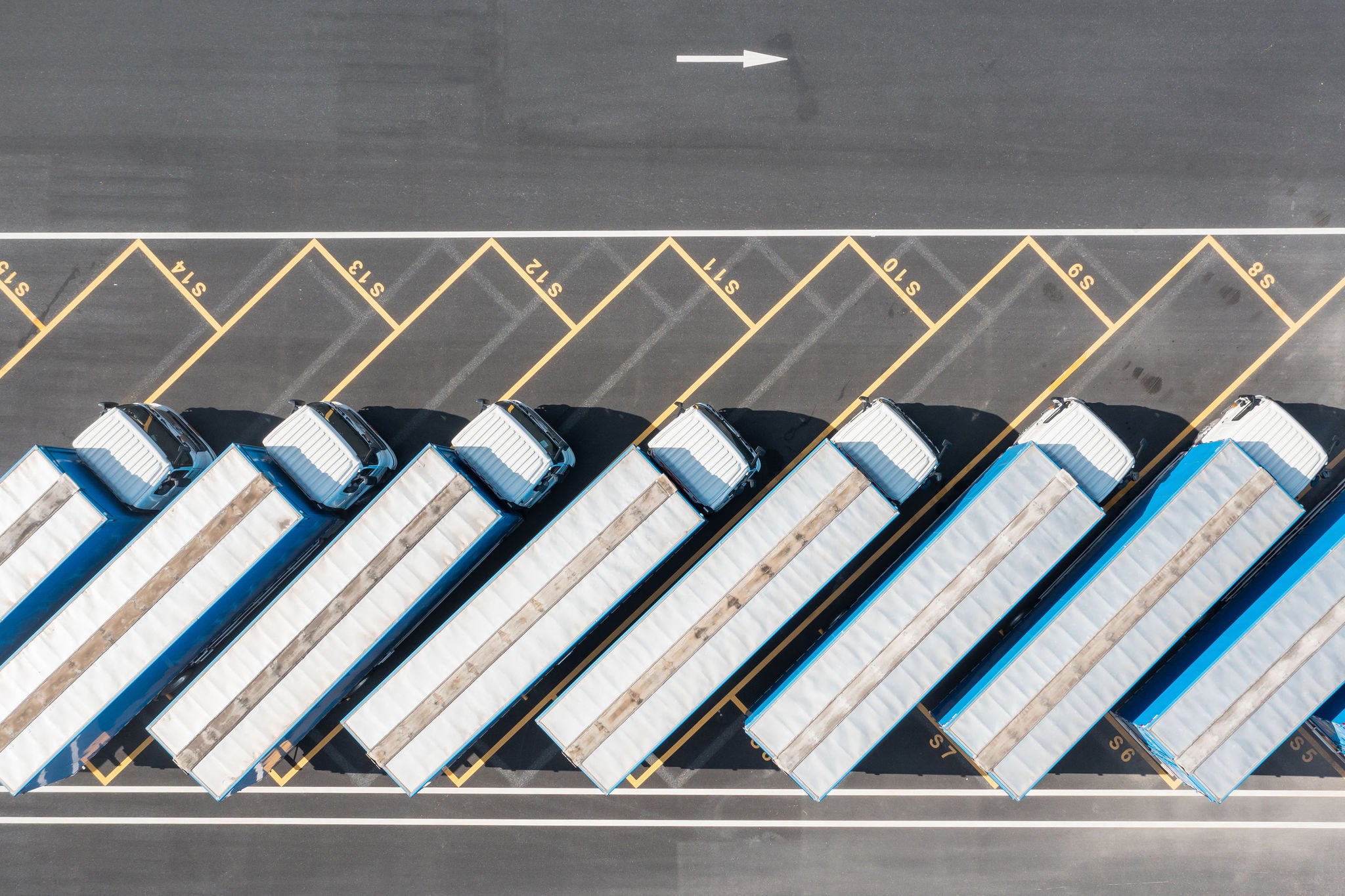 Overhead shot of a parking lot is full of trucks