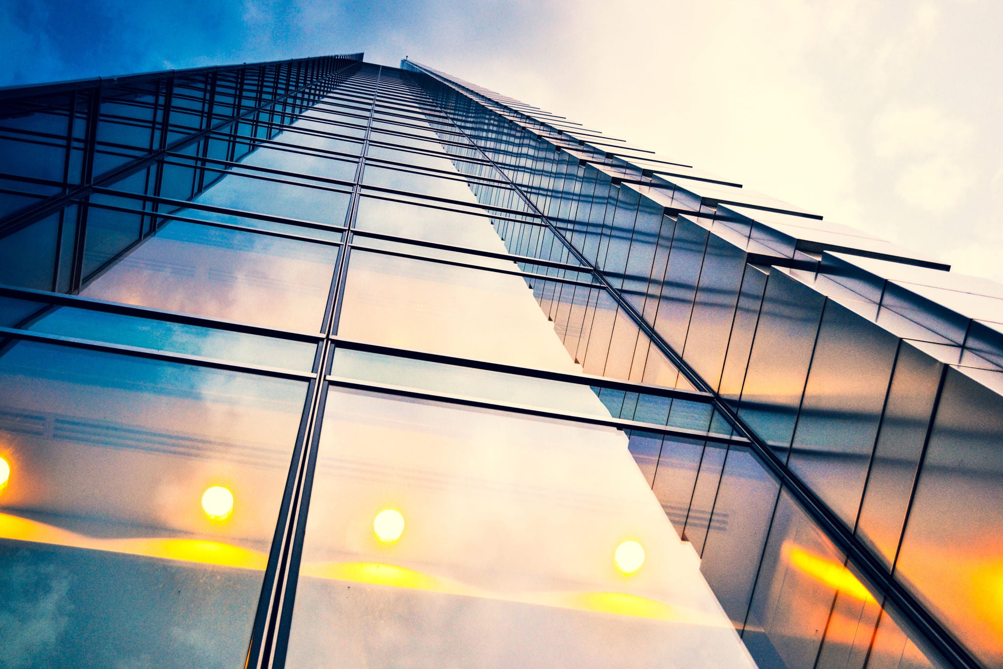 Man working on laptop while sitting in kitchen at home