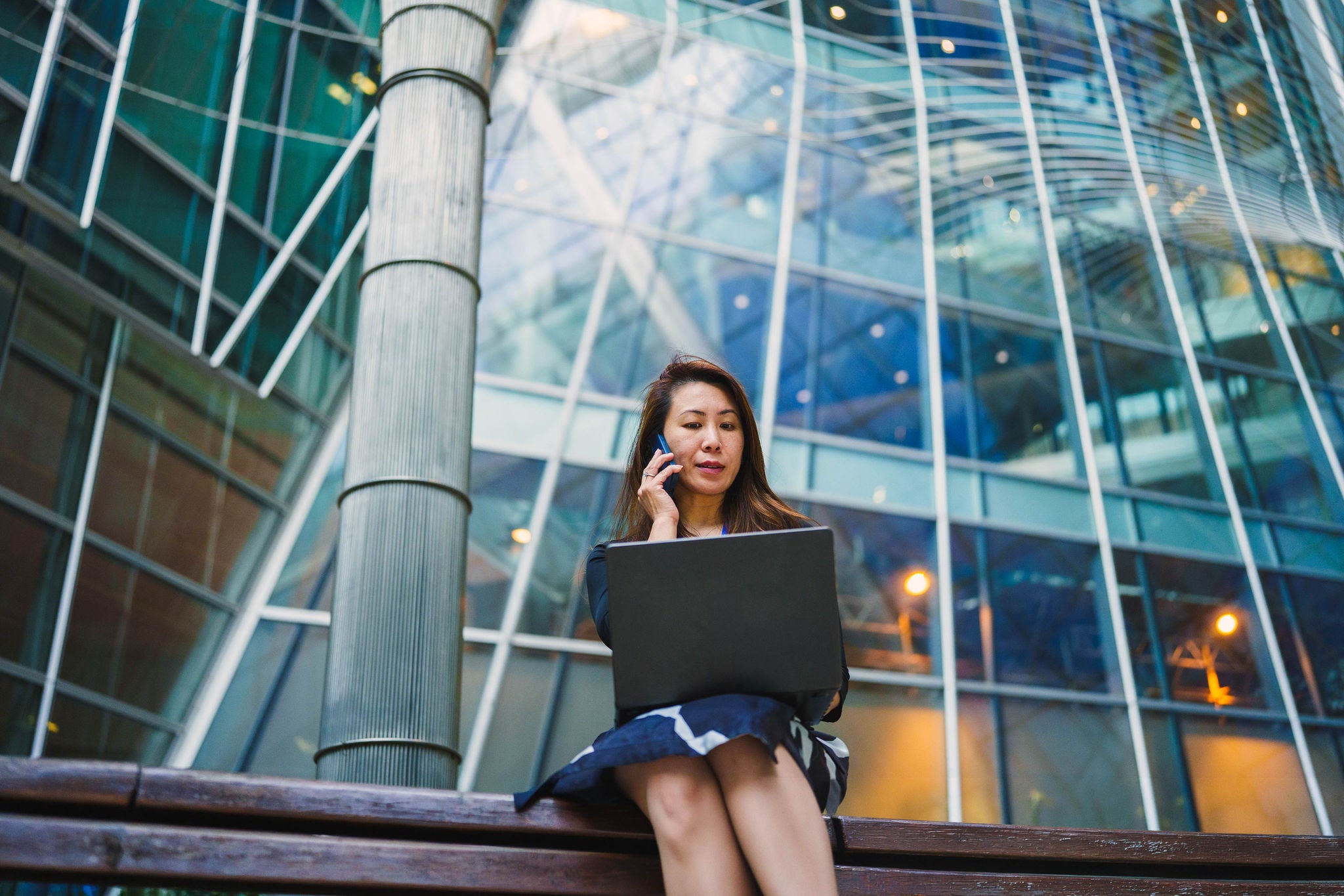 Business professional collaborating and working digitally in a contemporary urban workplace setting.