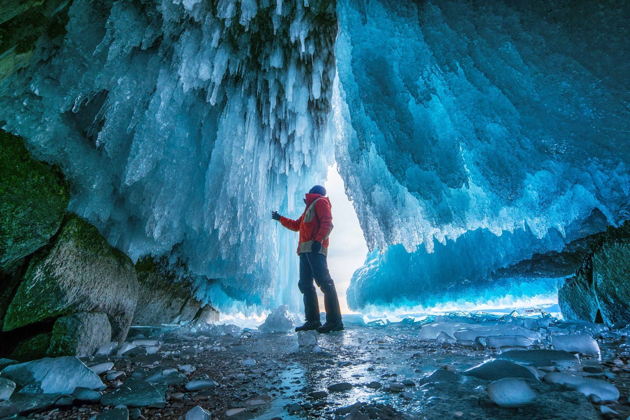 A picture of a man exploring an ice cave in Baikal region, Russia.
