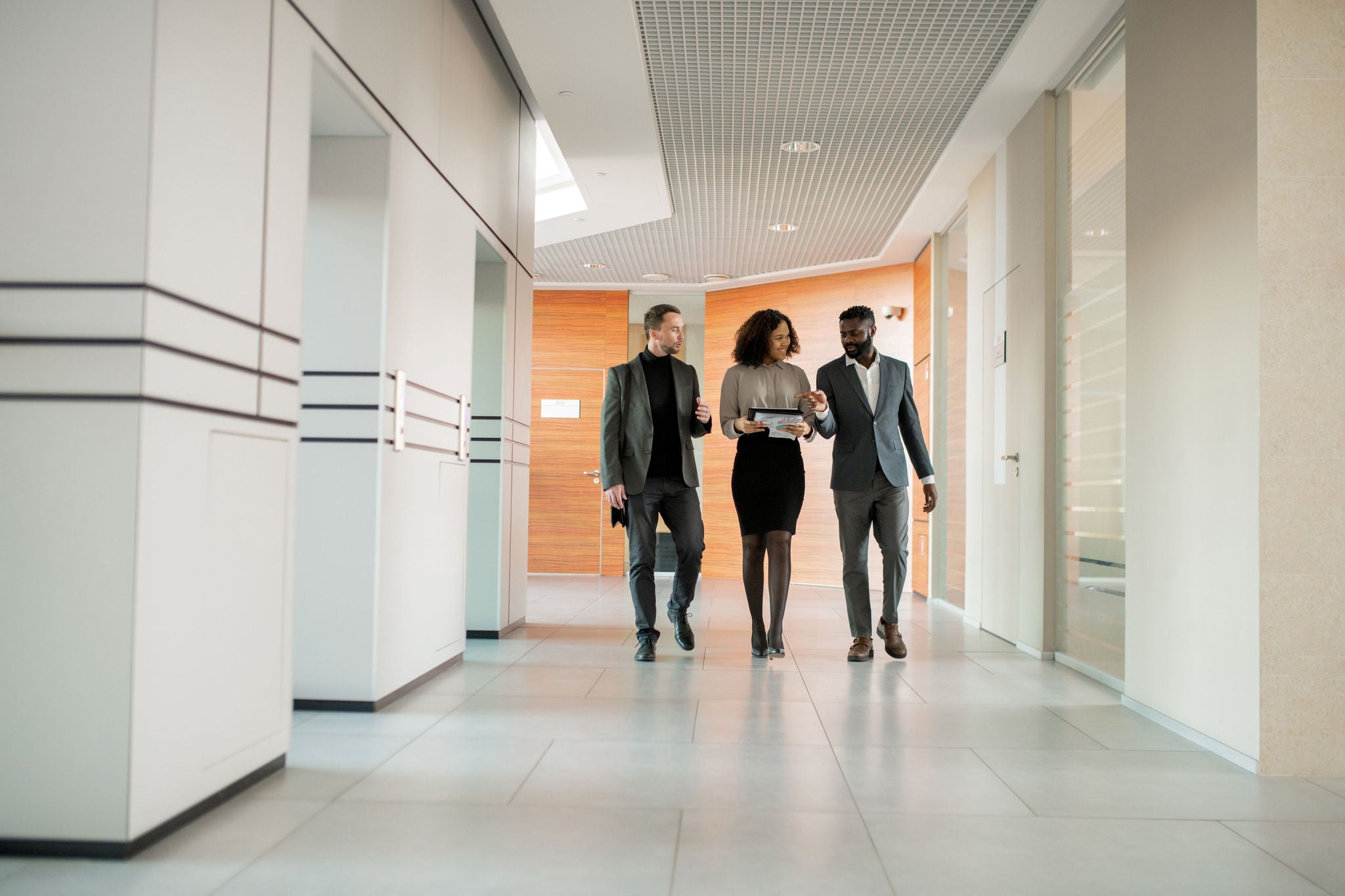 Colleagues walking in the hallway, talking about business