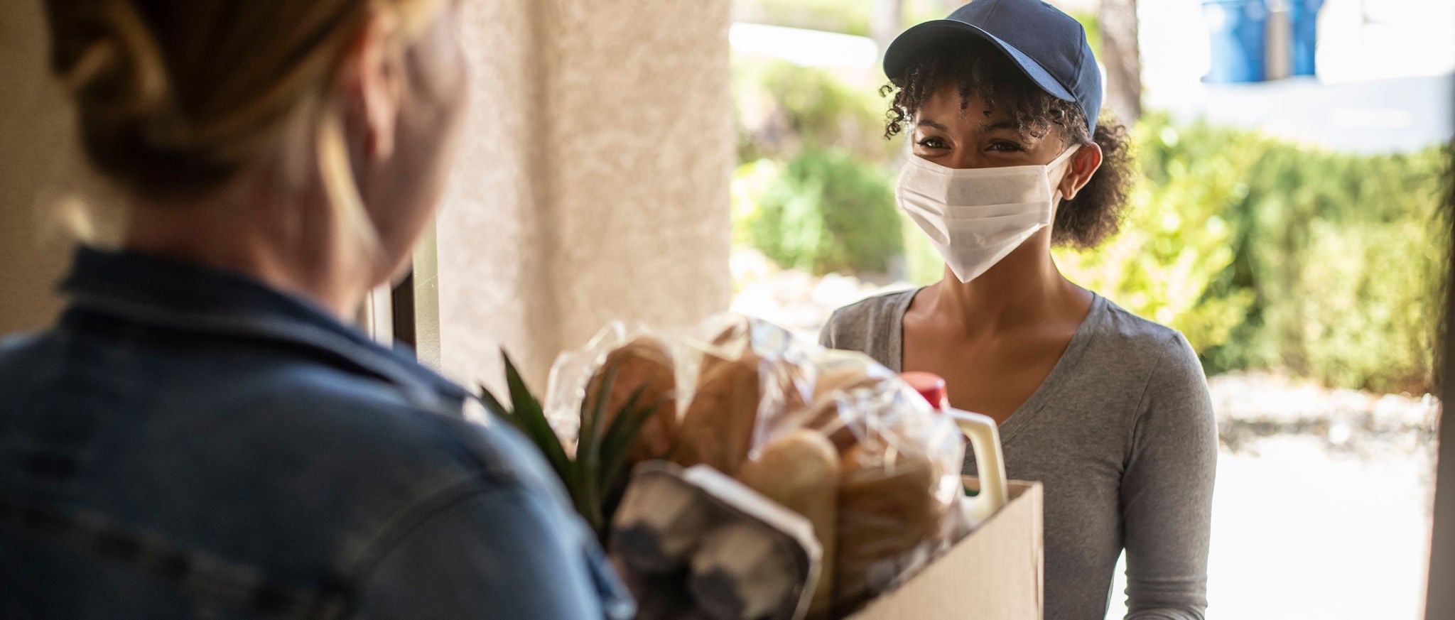 Woman in mask delivering food